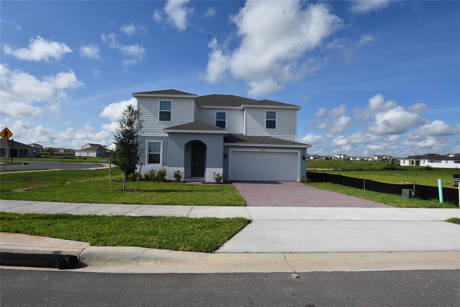 Brand New 2 story home the Lopez Model Located at the stunning community of Groveland Trinity Lakes. 5 bedroom 3 full bath. Spacious living room that opens up to the kitchen and dining Area. inside laundry. Kitchen with all stainless steel new appliances, stone counter tops and kitchen Island, closet Pantry. One Guest bedroom downstairs and full bath in the hallway. Office room with French Door. The Master bedroom is upstairs and Master full bath. The Master split with the remaining bedrooms are upstairs including one hallway full bath and a loft "or upstairs family room". All bedroom floors are carpeted. Wall-to-wall ceramic floors through out kitchen , bathrooms, Landry and office room. 2 car garage with electric remote controlled openers. Covered patio. Outside deliveries storage room with coded door lock.
Trinity Lakes Community has state of the Art Swimming Pool, club, picnic and play grounds. Quiet Country stile living. Conveniently located with easy access to C.R 19, Hwy 27 and Florida's Turnpike.