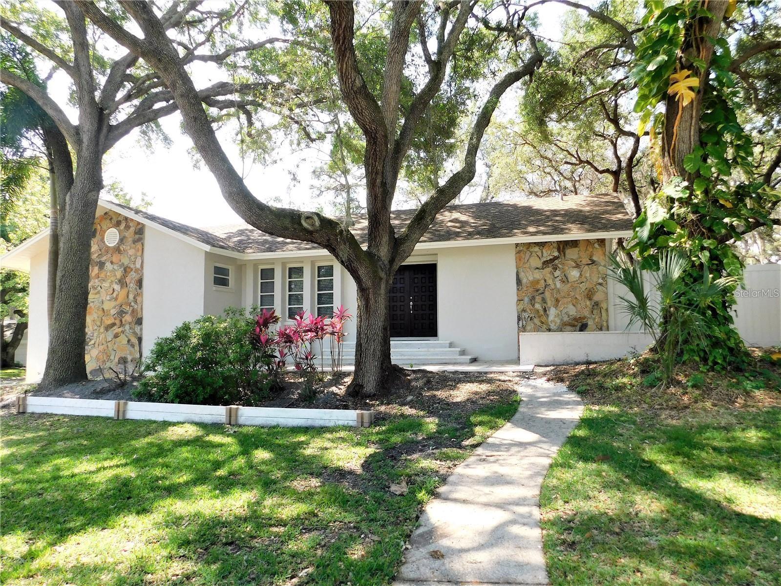 Beautiful 3 bedroom home in Bay Woods of Safety Harbor located on a corner lot. Double door foyer entrance into tiled open living room and separate dining area. Beautiful extended wood kitchen cabinets, granite counter tops and stainless steel appliances in the kitchen which overlooks family room with wood burning fireplace and vaulted ceilings. This home has a split bedroom plan with the master bedroom suite having beautiful flooring, sliding glass doors out to screen enclosed lanai, walk in closet and step down tiled shower in the master bath. Guest bedrooms with laminate flooring and updated bathroom. Sliding glass doors from the living area, family area and master bedroom out to extended tiled screen enclosed lanai overlooking fenced back yard. There is an attached 2 car garage with inside laundry room with washer and dryer hookup. NO PETS ALLOWED. This community is close to Philippe Park and a short trip to downtown Safety Harbor that offers various restaurants, marina, park, walking trails and entertainment.