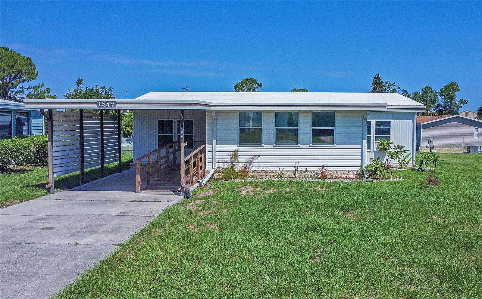 This spacious 2-bedroom, 2-bathroom home with New roof (2024) and recent HVAC system is nestled in the highly sought-after Lake Frances Estates, a resident-owned, 55+ active community in the heart of Tavares. NO LOT RENT AND YOU OWN THE LAND! Only $50 a month hoa fee! Step into a bright Florida room that leads into a generous open-concept living and dining area, featuring vaulted ceilings, wood-style flooring, and abundant natural light. The updated kitchen offers pantry shelving, skylights, and a window overlooking the sink, perfect for those Florida sunny mornings. This thoughtfully designed home features two spacious primary suites, each with their own en-suite bathroom and walk-in closet—providing privacy and comfort for both you and your guests. The home is wheelchair accessible, and move-in ready. The home features a shaded carport, a fully fenced backyard for your furry friend and enjoying the Florida sun, a large workshop/storage shed for hobbies, tools, or extra storage and an attached laundry room and craft area. Located just across the street from Winn-Dixie, JOANN Fabrics, and Twistee Treat, and minutes from downtown Tavares, Lake Dora, and Lake Eustis, you’ll have access to shopping, dining, healthcare and local festivals all year long. Enjoy Lake Frances Estates amenities include Indoor & outdoor heated pools, Clubhouse with bingo, card games, and movie nights, Fishing pier, Shuffleboard courts & billiards room, Golf cart-friendly community and Regular community events and social gatherings. This home has everything you need — comfort, convenience, and community. Don’t miss your chance to live in one of the most active and welcoming 55+ communities in Central Florida. With interest rates dropping, now is the time to act! Schedule your private showing today before this gem is gone!