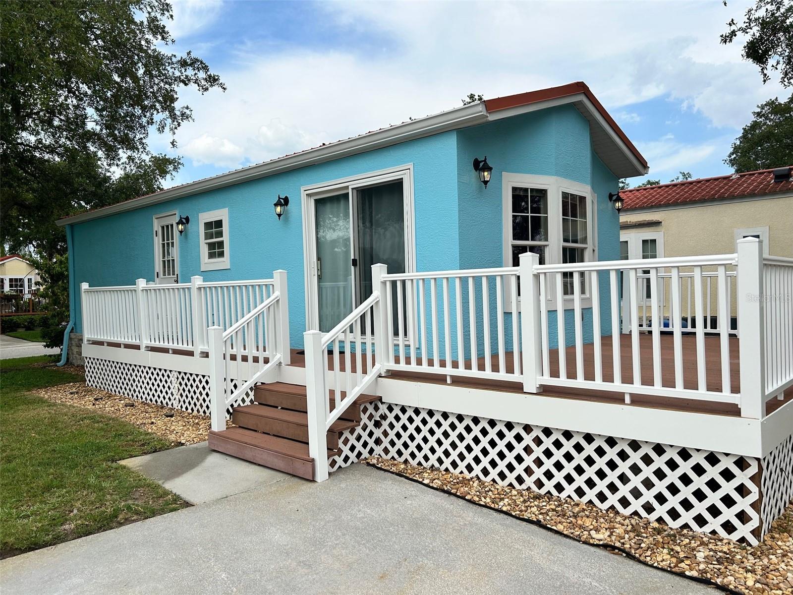 Here is your opportunity to own A piece of Caliente! A very affordable, well maintained, one bedroom- one bath Casita which sits on a large corner lot of a very quiet street and is priced to sell so it won't last long. This turnkey Casita features an open gallery kitchen that has new flooring 2024 with a lot of cabinetry and storage. The family room has new carpet, and the bedroom has new flooring also 2024. there are privacy curtains throughout the home. The outside of the Casita boasts a great deck with new railings and perimeter supports 2025. This large deck is perfect for happy hours, nude sunbathing and morning coffee! Outside exterior has been painted 2023. The large corner lot provides for extra parking for cars or golf cart. Living in the Casitas is like no other just ask all of your future neighbors. Monthly HOA is only $211.17 which includes lawn maintenance, this along with your low taxes and homeowners' insurance provides you with that affordable low maintenance lifestyle. This golfcart clothing optional resort lifestyle can be yours. Hurry this Casita won't last long. Call your local knowledgeable nudist friendly realtor Sophia or Toby (owner agent)