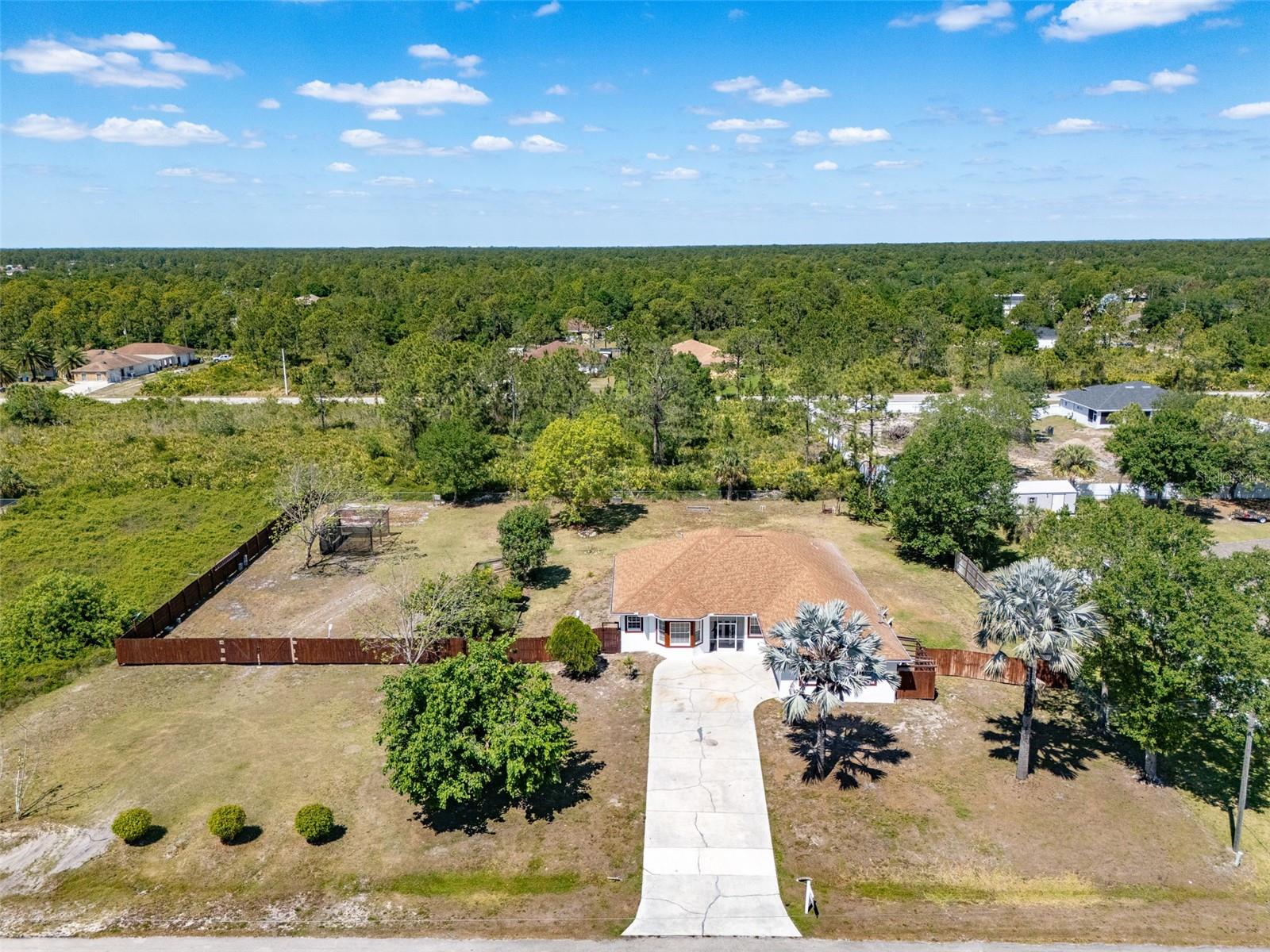 This beautiful Home on a 1 Acre fenced in property features 4 bed 4 bath, 2,410sqft of living space, No Flood insurance required, completely remodeled, Kitchen has high end quality quartz countertop, big PANTRY, tall cabinets with lots of storage, 2 lazy Susan, stainless steel appliances, washer and dryer included, screened in lanai, huge backyard with room for a pool, built in 2003, Roof from 2018, electric shutters on the main entrance and lanai