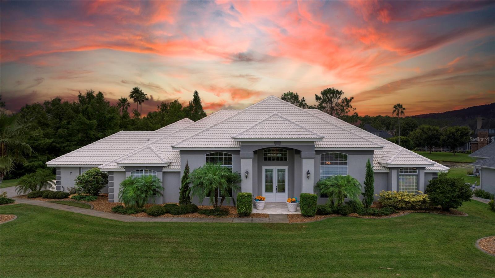 Welcome to 7 Foxford Chase, a spacious Lakefront Estate Home in the sought-after Hunters Ridge community of Ormond Beach. This 4-bedroom, 2 Full and 2 half Bathroom pool home sits on a large almost 1/2 Acre lot with a tiled roof, long driveway for plenty of extra parking, and 2-car garage. Step through the New Lead Glass double doors into a thoughtfully designed interior with amazing upgraded features . Vaulted ceilings throughout the living areas up to almost 13 ft. To the left is the formal dining room, and to the right, a formal living room perfect for additional seating or entertaining. Straight ahead, the sunken living room features three sets of French doors leading out to the lanai, and a built-in bar with glass cabinets, wine rack, sink, and mini fridge—ideal for hosting.
Just beyond, the spacious kitchen offers granite countertops, white cabinetry, a cooktop, double ovens, and a center island with sink, dishwasher, and breakfast bar overlooking the sunny breakfast nook.
The primary suite is tucked away for privacy, featuring French doors to the lanai, a walk-in closet, and a large en suite bath with dual vanities, private water closet, garden tub, and walk-in shower. The second full bathroom also includes a dual vanity and walk-in shower. A generous laundry room with utility sink and full wall of storage cabinets leads to the garage for added convenience.
Out back, enjoy your own private oasis with a New fenced yard, sparkling pool and spa, and a covered lanai with plenty of room for seating or outdoor dining. Enjoy the serene Lake with a beautiful fountain just beyond the pool. All of this is set within a quiet, established neighborhood.
Perfectly situated just minutes from top-rated schools, popular restaurants, grocery stores, and local parksplus, only 15 minutes from the beach. Don't miss outschedule your showing today!