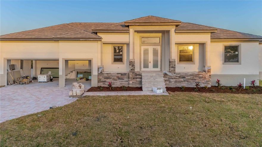 Under Construction. Welcome to Windward Isles, Punta Gorda’s newest maintenance-free waterfront community featuring 24 luxurious sailboat-access homes! This under-construction, never-lived-in residence offers a modern split-bedroom floor plan with high-end finishes and exceptional attention to detail throughout.This spacious home features three generous bedrooms, three full bathrooms, a formal dining area, massive great room, and a versatile bonus den/office. The gourmet kitchen is designed for both style and functionality, including 42” wood upper cabinets with accent glass inserts, a tiled backsplash, granite countertops, and a full stainless steel appliance package including a hood, oven, microwave, cooktop, refrigerator, and dishwasher. The luxurious master suite includes an expansive master bathroom with dual vanity, tiled shower, and large walk-in closet. Interior highlights include porcelain tile flooring throughout, an electric built-in fireplace, tall ceilings with recessed trays, coffers, and grids, crown molding, designer fixtures, and 5” baseboards. Step outside to your private outdoor oasis featuring a covered paver lanai, heated pool and spa, and 90-degree sliding glass doors that maximize natural light and views of the picturesque canal. The exterior boasts a seawall with boat lift and wood dock, perfect for boaters, along with a paver driveway and walkway, stone accents, high-impact windows and doors, tiled roof, irrigation system, and lush landscaping. Windward Isles offers a maintenance-free lifestyle with HOA-covered services including lawn care, irrigation, tree trimming, pest control, and fertilization. Located just minutes from Charlotte Harbor and the Gulf of Mexico, with easy access to Boca Grande, Fisherman’s Village, and Downtown Punta Gorda, and close to dining, shopping, and entertainment, this is the ideal place to call home.
Seasonal rentals are allowed, making it an excellent investment opportunity. Additional homesites and models are available. Developer financing is available at 5.99% for a 30-year fixed rate.