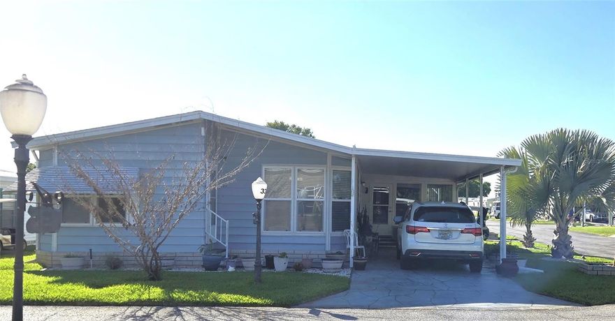 Resort Style Living! Own your own land! This beautifully updated home on a corner lot is bright with an airy layout. Freshly painted interior. The Kitchen has new appliances, eating area, reverse osmosis AND a whole house filtration system! Lots of storage in the double shed/golf cart garage, inside laundry room and well-sized rooms including the bathrooms.  Both bedrooms have ample closets.  Formal Dining room provides built-in shelves and storage with a pretty mirror backing. AC is 2012 GOODMAN with annual inspections, home is partially furnished, and it includes the golf cart! Dual-pane, tilt in windows, 2024 roof, and no grey pipe.  Tie-Downs just updated last year, and a AMERICAN HOME SHIELD GOLD PLAN home warranty that is transferable! The Florida Room is on house AC. GREEN FEES for owners are only $5.00! Review the pictures and watch the Walk-Through Video, then schedule your appointment to come see this premium lot and premium house! In this very friendly community, you can be as active or inactive as you choose! Enjoy 18 holes of golf for just $5 green fees in this Gated, Golf Community, located just outside of the city, and approx. 1.25 hr from either coast. Great access to Disney, Legoland, and BOK Tower, just to name a few local attractions. Gatherings at the private Pub or the Community Room with clubs to fit every interest, fishing on Lake Henry, gardening, pickle ball, tennis, golf, shuffle board, horseshoes, swimming in the heated pool, enjoy the hot tub or the 24/7 workout room! Contact this community's website for documents, including Rules/Regs, Application, Financial, and Bylaws. HOA INCLUDES a DVD Recorder and 2 BOXES FOR HD CABLE plus INTERNET! **55+ community with minimum age required is 50; rental max period 6 month out of a year.**