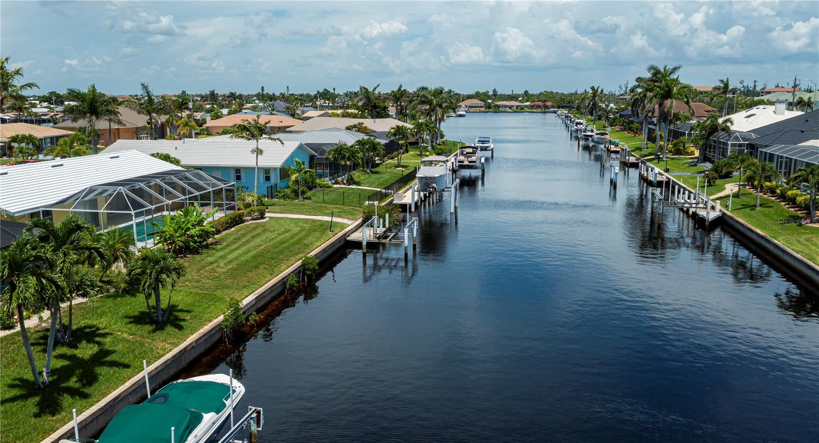 Your own piece of paradise is right here in this beautifully updated, super clean, waterfront, pool home! NO water damage from recent hurricanes, this home features a 2025 tile roof, PGT impact-resistant windows, and pool pump. Tile flooring throughout, newly painted inside & out, and stunning custom resin countertops in the updated kitchen, bonus interior dry bar area, and lanai. This inviting split bedroom floor plan home has been lovingly & tastefully updated with a newly renovated primary ensuite bathroom. This home boasts lots of thoughtful care from the lush, landscaped lawn and backyard and carries through to every room inside. New front & garage doors and Square D replaced main electric panel box. The lanai and large pool are perfect after your day on the water! What are you waiting for: the boat dock & lift need you & your boat! Call for your private showing today.