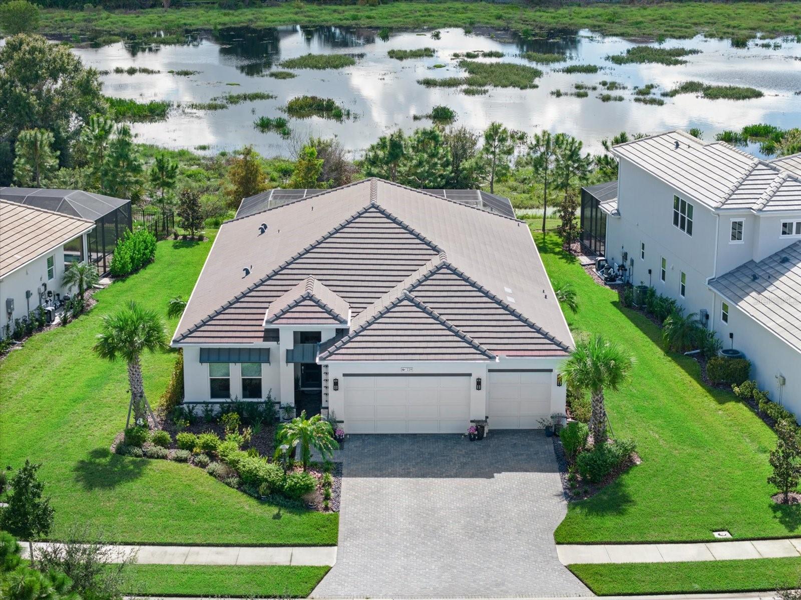 This home has many upgrades to consider. Lowest price home on Catamaran 65' lot collection & Larger than most lots on preserve. 3 Bedrooms, Plus Den/Office. 2 full baths, and 1 pool bath. Comes With FULL impact glass windows and doors throughout, Heated Pool with Spa, water feature and lights. Full security and cameras, Customized kitchen with extended solo island, added kitchen window over sink, added pool bath, two added exterior doors to lanai and pool area from kitchen and master, extended drive way, and no houses across the street in the front. 3 Bedrooms, Plus Den/Office.2 full baths, and 1 half pool bath. FULL impact glass windows and doors throughout, Heated Pool with Spa, water feature and lights. Larger than most lots on preserve. Full security and cameras, Customized kitchen with extended solo island, added kitchen window over sink, added pool bath, two added exterior doors to lanai and pool area from kitchen and master, extended drive way, and no houses across the street in the front. Custom designed main bath with dual vanities, half privacy for WC, oversized soaking tub, tile in both showers to the wall, upgraded tiles, counters, and full house luxury vinyl. (With exception of baths and laundry). custom laundry cabinets with farm house sink (great for dog baths). Kitchen with Zline appliances, and dual wine fridge. Custom main closet with drawers and shoe shelves, upgraded kitchen pantry shelves. Built ins in living room, added LED hookups, Smart house...and more. Note: No outside kitchen but there is room to add. Water filter whole house, electrical plug for EV Please note viewing this home there are active cameras inside the home. The Community has many social activities and great pool, fitness center club house and more. Come tour for yourself. All information to be verified with tax records, HOA and own buyer's due diligence. Required CDD verify amount, and HOA contributions at closing $750 CC and $2500 amenity fee. (lanai drapes removed as not allowed per HOA)