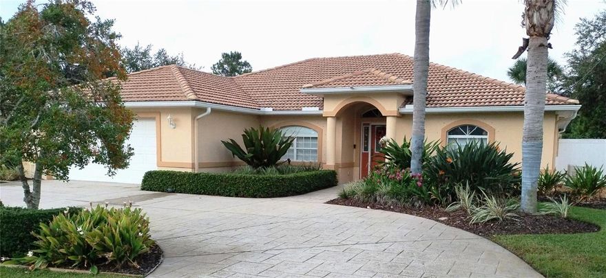 This is a meticulously maintained & updated Amaral built home, located in the desirable Trails subdivision which is convenient to schools, shopping and restaurants. A circular drive welcomes you to this beautifully landscaped home. It is prepared for hurricanes with a whole house Generac generator, AstroGuard Hurricane Fabric protection for the windows and a lifetime concrete tile roof. You enter the large open floor plan viewing the living room, dining room, breakfast nook with entry into the kitchen through an arched entry way. The exquisitely updated custom kitchen has off-white cabinetry with LED under cabinet lighting, all new appliances, granite countertops with full height granite backsplash. To the right of the entry is the master suite with a tray ceiling, plush carpet and adjoining en suit that has been completely updated utilizing LVP flooring, Veterra countertop, and a large walk-in shower. Located off the breakfast nook, the second bath has been updated with granite countertops, new light fixtures and glass shower enclosure. The second and third bedrooms have newly painted walls. All the closets have organizers installed. Relax on your large lanai which has been rescreened & has 3 6’ Coolaroo sunshades, porcelain tile floor and a TV/stereo entertainment system. The white vinyl privacy fence has double gates & a single gate opening. One of the two composite decks is covered with an 18’ retractable awning. The oversized two car garage has an insulated door with opener, and 6” of blown attic insulation. Additional garage upgrades include an attic lift, work area with storage cabinets, a water softening system, ceiling fans, and fluorescent lighting. Thermopane windows, gutters/downspouts, led lighting throughout the house, high-efficient HVAC system replaced in 2019, hot water heater replaced in 2018 round out the upgrades. The focus on detail throughout the home exhibits style and functionality.