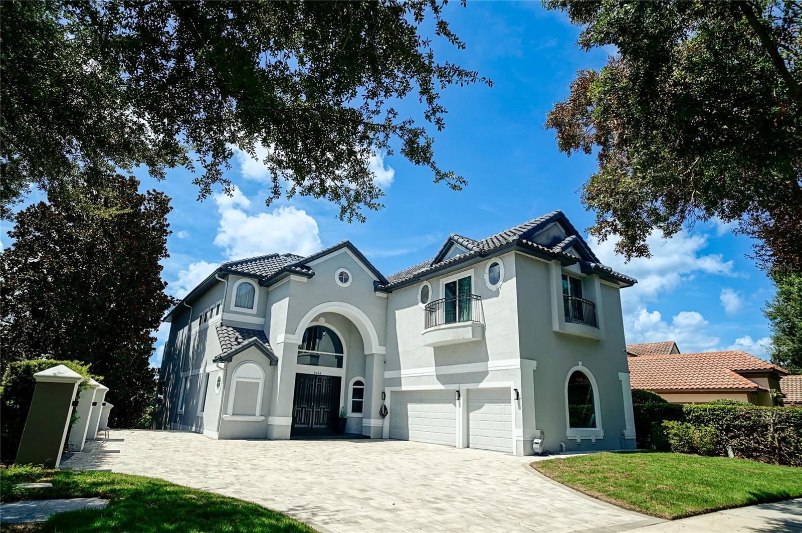 Presenting an exquisite, ultra-modern lakeview residence located in the esteemed Dr. Phillips area – an ideal find for those seeking luxurious accommodations. Embodying opulent living, this property at 8044 Firenze Blvd boasts an expansive floor area exceeding 7,000 square feet, artfully renovated to impress. Stepping through the grand front double doors, you will be welcomed into a truly magnificent space, perfect for hosting elegant dinner parties, adorned with soaring double-height ceilings that offer captivating views of the adjacent lake. The first floor is also complemented by a well-appointed office also overlooking the serene lake. Ascending to the second floor, you will discover five additional bedrooms. The master bedroom has been meticulously redesigned, capturing the essence of a five-star hotel experience, complete with a generously sized double shower and a rejuvenating jetted tub. If the accommodations on the first and second floors exceed expectations, prepare to be astonished by the lower level. Unveiling a complete secondary kitchen featuring exquisite waterfall-style stone countertops and state-of-the-art appliances – every chef's dream. Accompanying this magnificent kitchen, find an additional bedroom, a gracious living room, an elegant dining area, and a private theater space – culminating in an entertainment haven beyond compare. When you step outside, you will be delighted to find an incredible summer kitchen, complemented by an infinity pool and a spacious lounge area. Complete with picturesque views of the stunning lake, this outdoor space is perfect for relaxation and entertaining. Enjoy waterfront living with convenient access for your boat and jet skis at the dock! In addition to its extraordinary features, this property is situated in the highly coveted Doctor Phillips area. Within a five-minute ride, you will have access to a vibrant restaurant strip boasting the finest dining options in town. Not only that, but you'll also have convenient access to a variety of retail stores, banks, markets, dry cleaning services, salons, and everything else you can imagine. Enjoy the perfect blend of luxury, convenience, and a superb location in this exceptional property. Don't miss out on the opportunity to make this remarkable property your own. Contact us today to schedule a showing, as this highly sought-after home is sure to sell quickly.