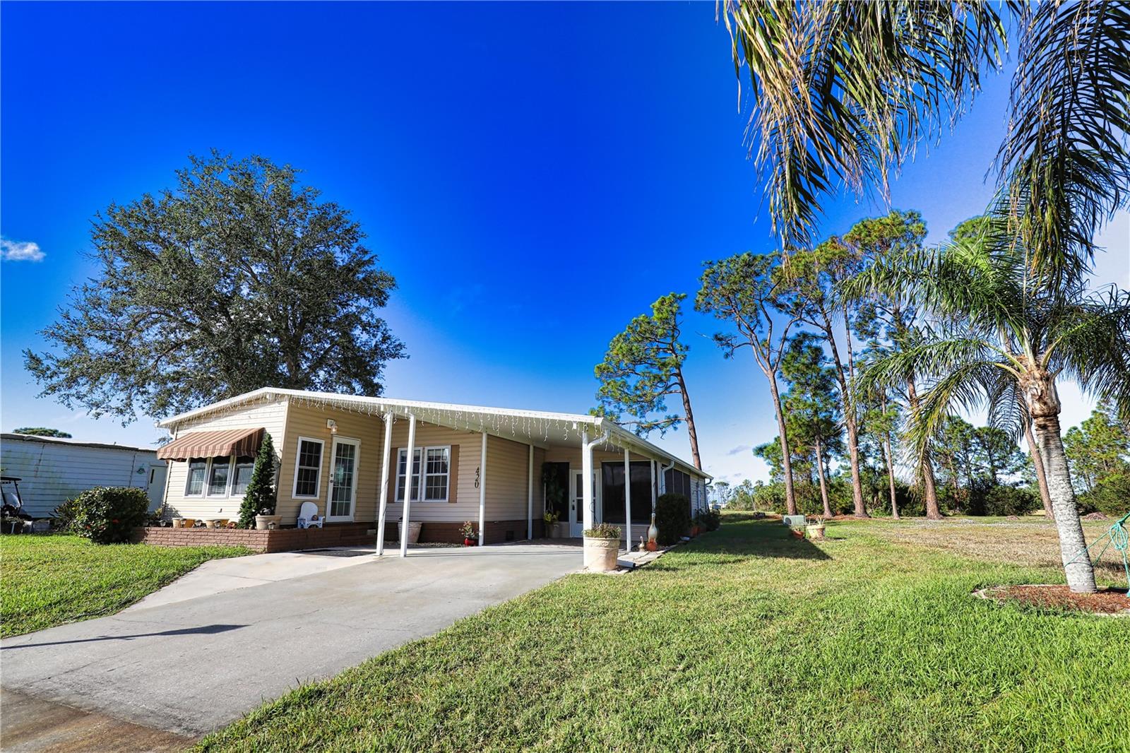 Don’t miss your chance to capture a piece of paradise! This charming home with stunning landscaping is nestled against 40 acres of untouched land in a vibrant 55+ community. As you walk inside the lanai you’ll find an extremely comfortable air-conditioned and carpeted room with an amazing view that can be used as an extra tv room or entertainment space. The home offers an updated kitchen with newer appliances. This opens to the dining room/living room combination that is inviting. The Florida Room on the front of the house is another added bonus room that is under air and carpeted and feels open and airy because of the vaulted ceiling. The guest room has a full size Murphy bed with shelving on either side and a walk in closet. The guest bath across the hall is generous in size. The primary bedroom with ensuite bath boasts 2 walk-in closets and a linen closet, and a walk-in shower. Outside the back of the home there is a paver patio that extends the length of the home for those comfortable evenings when you want to enjoy the outdoors looking at the beauty of the untouched 40 acres. This home is located in the pet section so your furry friend will be able to enjoy paradise too!
Don’t miss your opportunity to claim your slice of paradise! This enchanting home, beautifully framed by stunning landscaping, is nestled beside 40 acres of pristine, untouched land within a vibrant 55+ community. Step inside the inviting lanai and discover a cozy, air-conditioned haven adorned with plush carpeting and breathtaking views—perfect as an extra TV room or an entertaining space for family and friends. The updated kitchen boasts modern appliances and flows beautifully into the warm and welcoming dining and living room combination. Adding to the charm is the delightful Florida Room at the front of the house, also air-conditioned and carpeted, which exudes an open and airy ambiance thanks to its soaring vaulted ceiling. The guest room features a full-size Murphy bed, complemented by stylish shelving on either side and a spacious walk-in closet. Conveniently located across the hall is the generously sized guest bath. Retreat to the primary bedroom, where you'll find an ensuite bath that includes two expansive walk-in closets, a linen closet, and a luxurious walk-in shower. Outdoor living is effortless on the paver patio that stretches the length of the home, creating an idyllic setting for enjoying peaceful evenings while soaking in the enchanting views of the untouched 40 acres. And for your furry companions, this home is situated in the pet-friendly section of the community, ensuring that they too can revel in the joy of paradise! Don’t let this remarkable opportunity slip away!