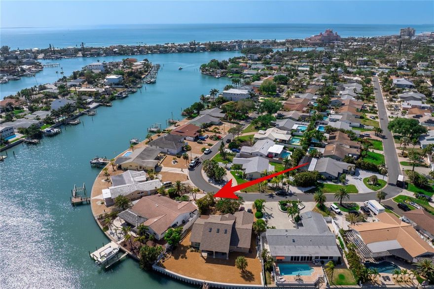 So many surprises to discover in this warm and inviting waterfront home on Vina Del Mar Island...This home includes the most amazing indoor and outdoor spaces!  Some of the outside attributes include 115 ft of deep waterfront, a fully appointed 2024 dock with 15K lb boat lift.  Outdoor entertaining will never get better with the perfect combination of Travertine and a Tiki Hut that duplicates an authentic palm tree thatch but made from sustainable materials that withstand the elements and create a gathering place to absolutely fall in love with.  The entire indoor living space creates the warmth of saltillo flooring while creating seamless flow throughout all the fun and function this home provides. The kitchen truly is the heart of the home and is perfectly placed to be where everyone will want to gather.  A true chef's kitchen with all the amenities including double oven, warming drawer, walk in pantry, and the separate wet bar includes the ultimate ice maker.  The primary suite offers private water views and patio access, with a spa-inspired bath featuring dual vanities, glass shower, garden tub, separate water closet, and two walk-in closets. On the opposite side of the home is 3 add'l bedrooms with one of the guest rooms having access to the covered patio. Pella Casement Windows and Doors, whole house water purification system, plenty of additional storage, and plenty of room for a pool. Enjoy an unparalleled lifestyle on desirable Vina Del Mar Island, just minutes from the white sandy beaches, charming Pass-A-Grille, and vibrant downtown St. Petersburg.  Golf Cart friendly, walk to the park, spectacular sunrises and underground utilities compliment this specific location.
