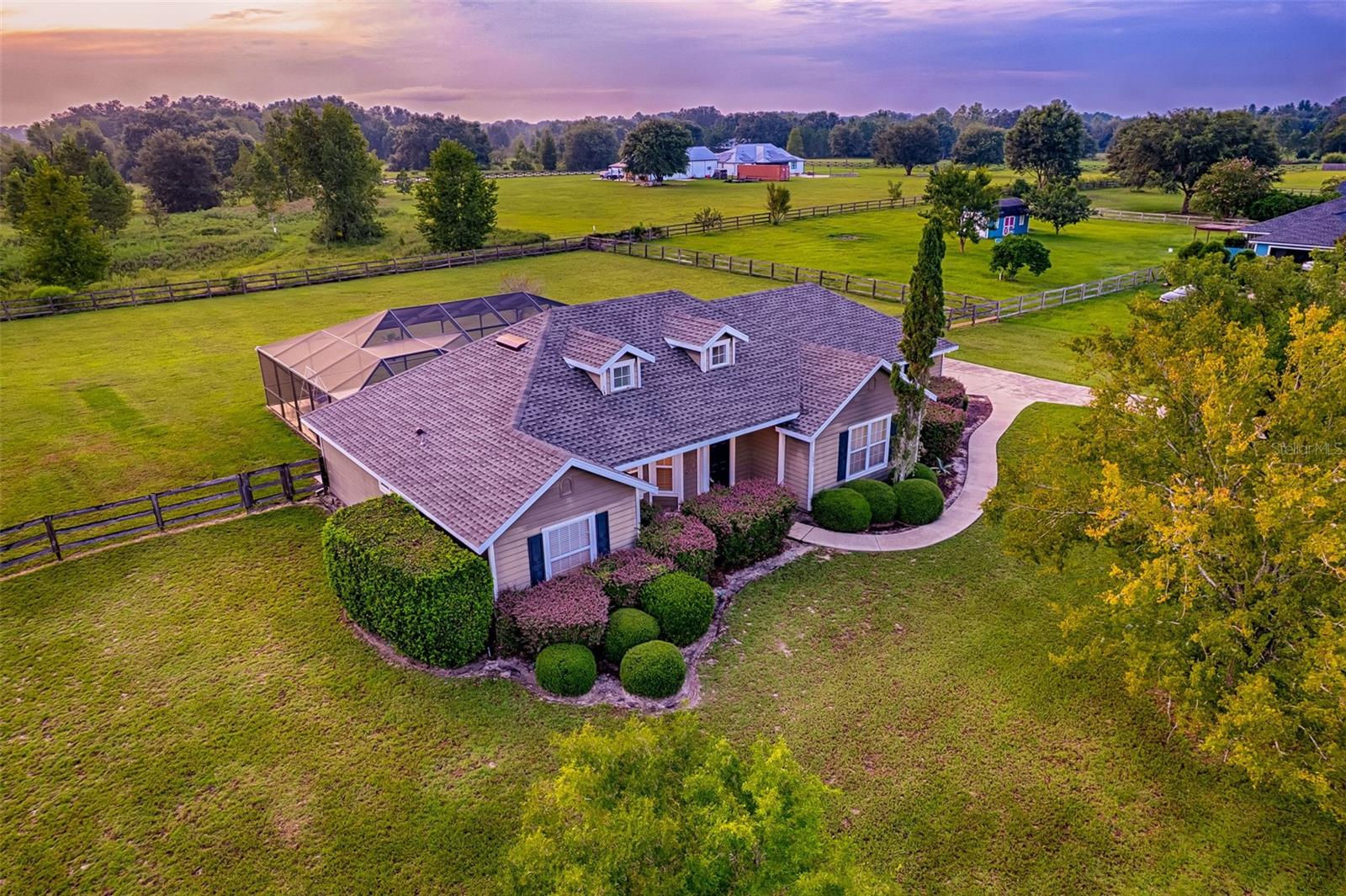 End each beautiful Florida day with a sunset swim at this well-maintained home resting on a full acre of land in the Hammock Ridge subdivision of SW Gainesville. This 3-bedroom 2-bathroom home has amazing views of the western sky from inside the home, and for nature lovers the large screened in pool enclosure with brand new screens gives you so much outside space to thrive. The custom pool has a shallow area for lounging chairs, as well as a salt system, new pump, an inviting pool deck space, and a removable fence for safety. The large grassy backyard is a blank slate for gardening or just enjoying the peace and quiet. Inside the home there is a primary bedroom with a walk-in closet and a great bathroom with a separate walk-in shower and large tub. On the other side of the home, there are two guest rooms sharing another full bathroom. There is carpet in the bedrooms and wood floors in the great room. This home has had conscientious owners and it shows in its condition, making it truly move-in ready. The kitchen and dining area face the pool and backyard, and all kitchen appliances are recently updated. This home offers a side-entry two-car garage, ample driveway parking, fully fenced backyard, and a new roof in 2022. Make an appointment to see this home and experience the gorgeous view!