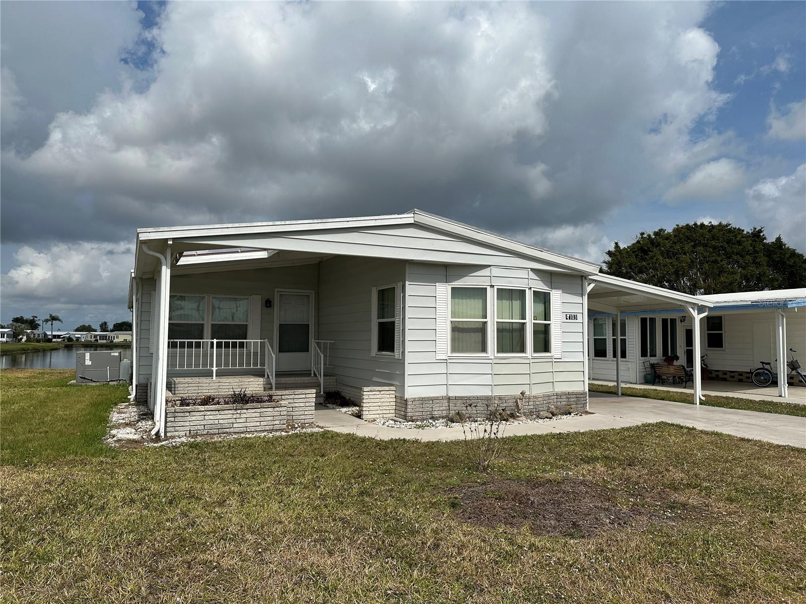 Welcome to 103 Lake View Drive, a bright and welcoming home located in the secure, gated 55+ community of Harbor Isles in North Port. This well-maintained 2-bedroom, 2-bathroom residence offers comfortable living with a layout designed for both relaxation and functionality. Whether you're looking for a full-time Florida retreat or a seasonal escape, this home is ready for you to move in and enjoy.
Step inside to find a spacious open living area filled with natural light and complemented by neutral finishes. The kitchen features ample cabinetry, a breakfast bar for casual dining, and direct access to the dining and living areas, making entertaining a breeze. A large enclosed Florida room adds additional year-round living space, perfect for morning coffee, quiet reading, or hosting guests.
The primary bedroom offers an en-suite bath and generous closet space, while the guest bedroom and second full bath provide a comfortable setup for visitors. Outside, the property includes a covered carport and attached utility shed, ideal for extra storage or hobby space.
Residents of Harbor Isles enjoy access to a wealth of amenities including a clubhouse, heated pool, fitness center, tennis, pickleball, and boating access to the Myakka River and Gulf. With close proximity to Gulf beaches, shopping, and dining, 103 Lake View Drive offers a wonderful opportunity to embrace the Florida lifestyle in a friendly and active community.