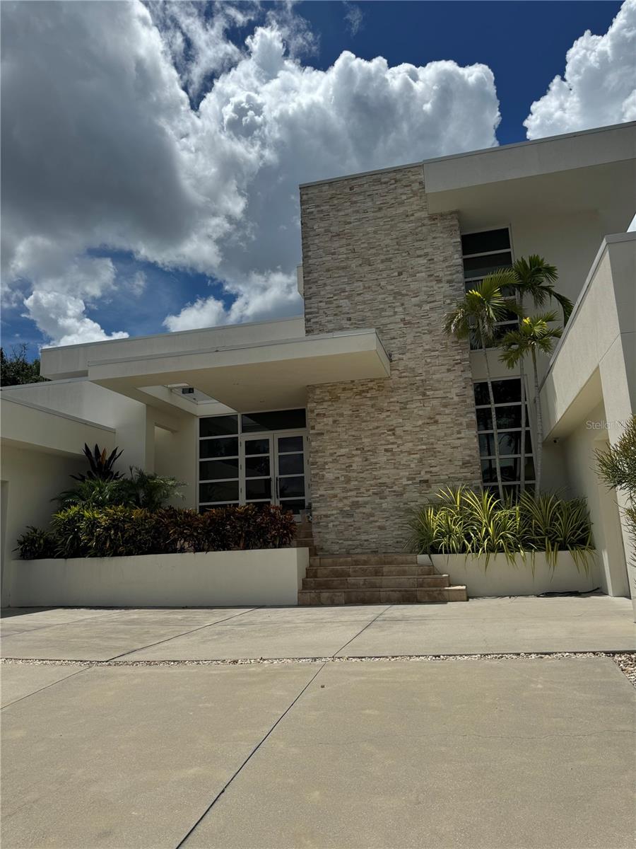 ***PROFESSIONAL PICTURES COMING SOON***
Discover unparalleled luxury in this stunning home located in the one of the most prized addresses in Sarasota HARBOR ACRES neighborhood. This exceptional residence features 5 spacious bedrooms, perfect for family and guests, and a versatile home office for those who work remotely.
As you approach, admire the elegant circular driveway and beautifully landscaped front yard. The entrance boasts a dramatic stone feature wall and double doors, welcoming you to your next chapter of elegance and comfort.
The expansive great room is filled with natural light and seamlessly connects to an outdoor living space, creating an ideal setting for gatherings. A stylish gas fireplace flanked by modern floating shelves enhances the cozy ambiance.
The gourmet kitchen is a chef’s dream, featuring high-end Miele appliances, custom solid wood cabinetry, quartz countertops, and a spacious island perfect for entertaining. The convenient butler’s pantry adds extra functionality for effortless hosting.
Retreat to the luxurious first-floor master suite, complete with two generous walk-in closets and a spa-like bathroom offering serene tropical views—a perfect escape after a long day.
Each of the five bedrooms is thoughtfully designed, ensuring comfort and privacy, with two additional en-suite bedrooms located upstairs for family or guests.
Additionally, the property features a unique converted garage that has been transformed into a fully-equipped home gym, providing a perfect space for workouts without leaving the comfort of your home.
Step outside to the stunning lanai, featuring an outdoor kitchen, a heated salt-water pool with an infinity edge, and a cozy firepit surrounded by lush landscaping for ultimate privacy.
Excellent Schools, Close to Morton's Market, Local Restaurants, Shopping, Sarasota Memorial Hospital, Downtown Sarasota, St Armand's plus Easy Access to the Best Florida Beaches!
Make this luxurious residence your new rental home in the sought-after Harbor Acres community today!