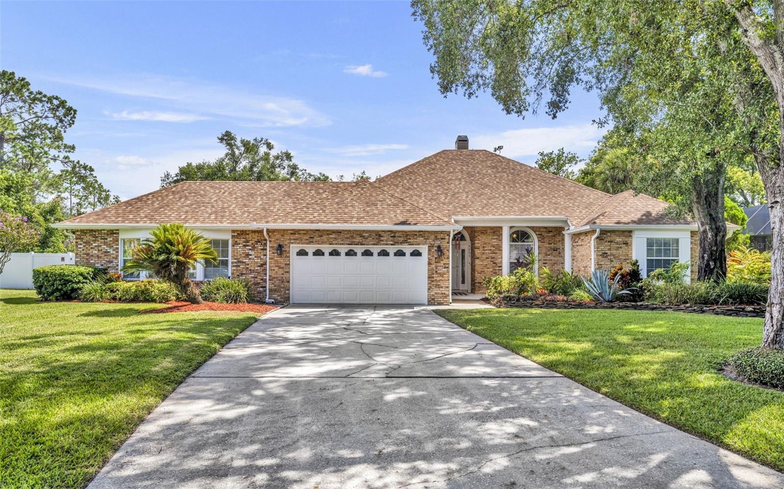 Expect to be impressed with this exceptional estate home in desirable Tall Trees! Nestled on nearly a HALF-ACRE cul-de-sac lot, this residence showcases a beautifully manicured lawn, LUSH landscaping, and a thoughtfully designed layout for COMFORTABLE everyday living. Inside, the living and dining rooms are anchored by a striking two-sided stone fireplace, while French doors open from the living room to the covered lanai. The kitchen is a CHEF'S DELIGHT with rich wood cabinetry, abundant counter space, a movable island, and a built-in desk for added convenience. The OWNER'S RETREAT is truly a sanctuary—featuring a 33x13 suite with two VERSATILE living areas, direct pool access, and an ensuite with a beautifully tiled WALK-IN SHOWER, soaking tub, and dual vanity with granite counters. Two secondary bedrooms and a full bath are tucked off the family room, while a unique fourth bedroom suite functions perfectly as a PRIVATE STUDIO APARTMENT. With its own separate entrance, full bath, and bright picture window, it’s ideal for guests, extended family, or even rental potential. Outdoors, the ROOMY FENCED BACKYARD ensures privacy for enjoying the SPARKLING POOL and patio. And just across the street, you’ll find community pool, PICKLEBALL/tennis/racquetball courts for even more recreation. Recent updates—including a BRAND NEW ROOF and 2024 water heater—add PEACE OF MIND to this already outstanding property. This home shows beautifully and is ready to WELCOME its next owners.