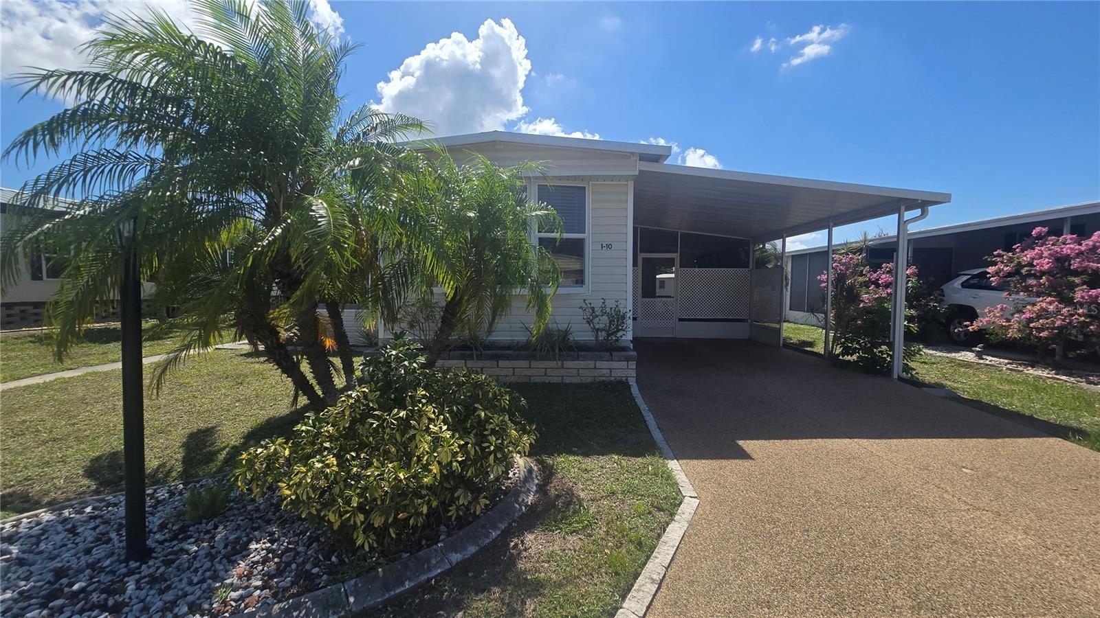 Welcome to WestWinds! This charming 2-bedroom, 1.5-bath singlewide home has been lovingly maintained and offers an abundance of outdoor living space—perfect for enjoying Florida’s beautiful weather. Inside, you'll find laminate flooring throughout, epoxy-painted for a clean, modern look. The spacious living area features a bright bay window that fills the room with natural light. The primary bedroom includes a custom built-in closet with ample space for clothes and storage. The adjoining full bathroom offers a walk-in shower, single vanity, and a conveniently tucked-away stackable washer and dryer. The second bedroom connects to a half bath, ideal for guests, and there's a dedicated office space that could easily be converted into a third bedroom if needed. Step outside and discover truly exceptional outdoor spaces. Enjoy the enclosed Florida Room with windows that open for airflow or close to create a separate cooled space with its own window A/C unit. On the opposite side, you'll find a screened-in lanai perfect for relaxing, a spacious open patio for entertaining, and a large outdoor shed for additional storage. WestWinds Community offers a welcoming, peaceful atmosphere with friendly neighbors, smiles, and waves around every corner. Best of all, pets are welcome—up to two with no weight restrictions! Residents enjoy a variety of social events and amenities, including community clubhouse with kitchen and covered outdoor BBQ, laundry room, library, bingo, crafts, card games, shuffleboard, bocce ball, billiards, horseshoes, and more. The large heated community pool and hot tub are perfect for relaxing year-round. There's even RV and boat storage available at special resident rates. Convenient location close to famous Gulf beaches, restaurants, SRQ Airport, shopping, theaters, St. Armands Circle and so much more. Don't miss the opportunity to make this delightful home in WestWinds your new Florida retreat!