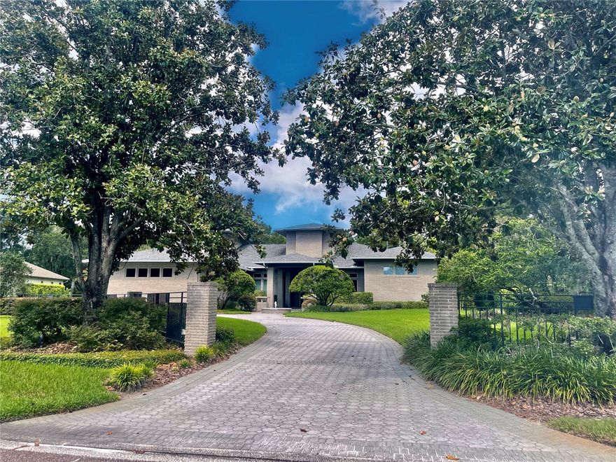 Surround yourself in luxury and privacy in this beautiful home located in Tampa's premier guard-gated community, Avila. Based on a Frank Lloyd Wright design, this estate offers 150 ft. of golf course frontage and features 7,584 sq ft of luxury living space. Custom designed and built by Alvarez Homes in 1996, this estate offers spectacular views of the 4th fairway. Featuring 5 bedrooms, 6 full & 2 half baths, a library/office with gorgeous custom wood built-ins, a magnificent theater room adorned with custom millwork & theater seating, & an upstairs bonus room. The outdoor living and entertaining spaces feature an oversized covered lanai with a spectacular heated pool and spa, a cabana with an outdoor kitchen, and gorgeous golf course views. The formal living and dining rooms are enhanced with volume, tray and dome ceilings, detailed crown molding and millwork, wood and marble flooring and a custom buffet. The chef's kitchen features beautiful cabinetry highlighted with granite countertops, 2 ovens, a warming drawer, and a breakfast bar. The family room features a gas fireplace, custom wet bar, and beautiful wood beamed ceilings. A beautiful master suite is enhanced with a relaxing sitting area, fireplace, adjoining exercise room, and master bath finished in tra