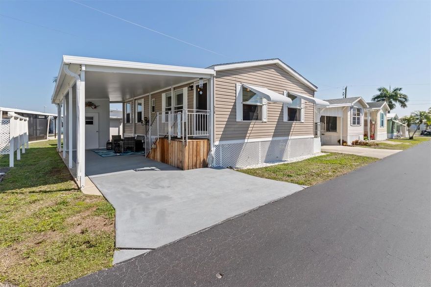 Absolutely adorable and move-in ready, this 2-bedroom, 2-bath home in the desirable Lazy Lagoon community offers comfort, convenience, and peace of mind! Built in 2007 and thoughtfully updated, this 805 sq. ft. home features a newer roof (2022), AC system (2020) with a brand-new motor (2025), and a hot water heater replaced in 2025—giving buyers confidence in all the big-ticket items. Step inside to find fresh paint throughout and beautiful luxury laminate flooring in the main living areas. Both bedrooms offer newer carpet, spacious closets, and plenty of natural light. The primary suite includes a private en suite bath with a walk-in shower and built-in seating, while the second bathroom features a tub/shower combo—perfect for guests. The kitchen comes fully equipped with all appliances included—even the washer and dryer, conveniently located inside the home. Additional upgrades include new ductwork (2025), updated skirting with lattice, and awnings on all windows for added protection and privacy. Enjoy outdoor living with new concrete steps leading to the side yard, plus the added bonus of no neighbors on one side for extra privacy. The one-car carport includes a secure storage shed with shelving—ideal for tools, beach gear, or seasonal items. Located directly across from the community recreation center (which also serves as a hurricane shelter), this home offers both convenience and security. Lazy Lagoon isn’t just a place to live; it’s a lively waterfront community with many great features. Residents enjoy a private road, extra guest parking, and an exclusive boat ramp that makes it easy to launch a boat or kayak and explore the scenic waters of Shell Creek. For fishing enthusiasts, the convenient fish cleaning station helps make every catch easier to prepare. The spacious 2,000-square-foot clubhouse includes a commercial kitchen and hosts many community events and gatherings throughout the year. Shuffleboard courts and a billiards and pool room offer fun activities just a short walk away. Boating enthusiasts will appreciate the community’s more than 2,000 feet of well-maintained shoreline and a private secured compound where boats and trailers can be stored for a small yearly fee. The location also places you just minutes from Punta Gorda, where you’ll find excellent dining, shopping, waterfront parks, and entertainment. Don’t miss this chance to enjoy peaceful waterfront living in a well-maintained and amenity-rich community. Call today to schedule your private tour and experience everything this home and Lazy Lagoon have to offer!