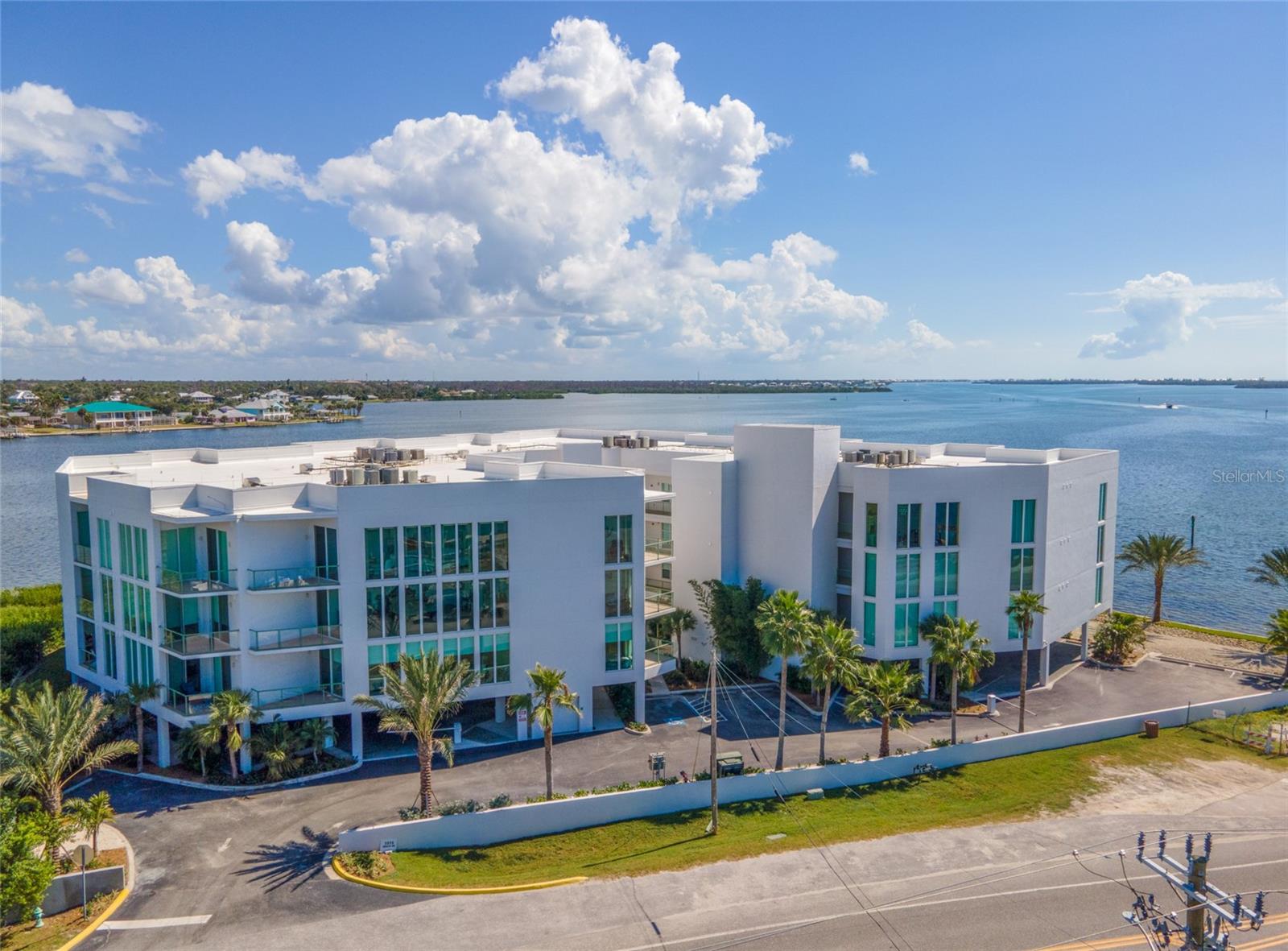 Wake up to panoramic WATER VIEWS OF LEMON BAY in this stunning Redfish Key Villas condo. Perfectly blending luxury and coastal living,  every inch of this furnished waterfront retreat has been thoughtfully curated for comfort, style, and effortless enjoyment. ~~~After a day of collecting shells just minutes away at Englewood Beach, park in the gated garage and take the ELEVATOR up to your private slice of paradise. Step inside and be greeted by a bright, open floor plan filled with natural light and sweeping water views. Whether you’re relaxing in the spacious living area, dining with the backdrop of Lemon Bay through FLOOR-TO-CEILING WINDOWS, or savoring your morning coffee at the BREAKFAST BAR, every moment feels like a postcard. ***The modern kitchen is a true showstopper with stylish tile backsplash, gleaming GRANITE COUNTERS, STAINLESS-STEEL APPLIANCES and a generous island that makes entertaining a breeze. The primary suite is your personal sanctuary, complete with a WALK-IN CLOSET, a PRIVATE BALCONY, and a spa-like EN-SUITE BATHROOM with dual vanities, granite counters, a soaking tub, and a separate walk-in shower. The guest accommodations are just as luxurious with a walk-in closet in the bedroom and granite counters in the full bath. A laundry closet for your convenience and a SECOND BALCONY round out your oasis. ~~~Outside your door, enjoy resort-style amenities including a sparkling COMMUNITY POOL, and of course, your deeded dock and boat lift, ideal for sunset cruises, fishing adventures, or exploring Lemon Bay and the Gulf. Located just one mile from Englewood Beach or venture to three other beaches on Manasota Key. Indulge in a variety of local dining and shopping options or take a short drive to historic Dearborn Street for farmers markets and concerts, visit numerous golf courses in the area and more. A private dock and 10,000-lb boat lift are available separately, completing the picture of true waterfront living and making every boater’s dream a reality. ***The true coastal Florida lifestyle is waiting for you to call this condo home. Call now to schedule a showing before this opportunity passes you by!