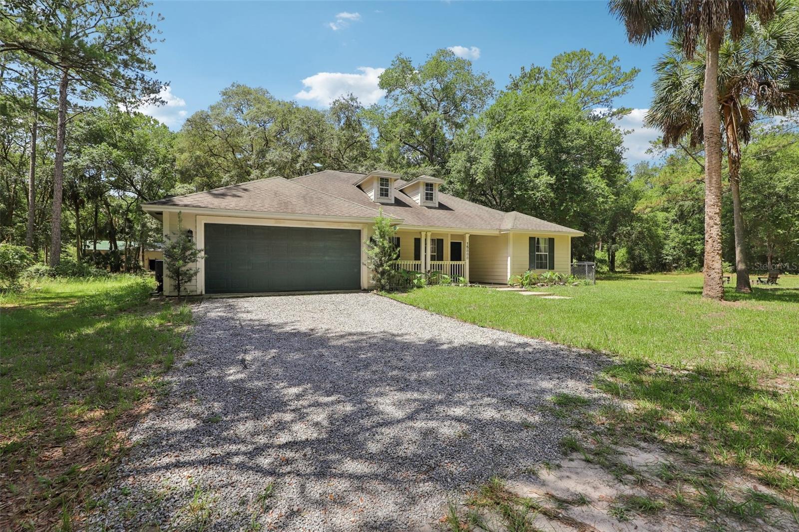 Tucked away in the peaceful Ocklawaha River Landings community, this 3-bedroom, 2-bathroom single-family home offers 1,591 square feet of updated living space on nearly 8 private, wooded acres. Surrounded by forest, the setting is ideal for anyone seeking privacy, space, and a connection to nature. One of the property’s standout features is the 1,400 sq ft barn, which can be used for a 8 stall horse barn, living space, workshop or whatever you desire. There’s water and electric connections and naturally stays cool all year with the concrete slab. Inside, the home is warm and welcoming, with vaulted ceilings, modern finishes, and an open layout. The kitchen is designed for both functionality and style, featuring stainless steel appliances, a breakfast bar, and ample counter space. The primary bedroom includes tray ceilings and an en suite bathroom with dual sinks, a soaking tub, and a separate shower. Recent upgrades include, 3 acres of land clearing, a new water filtration system, with water softening and reverse osmosis. Located in the heart of Fort McCoy, this property puts you within easy reach of Florida’s outdoor treasures. Explore the scenic beauty of Ocala National Forest, take a dip in the crystal-clear waters at Salt Springs which is 19min away, Silver Springs 25min away, or enjoy a day of boating or kayaking the nearby rivers like Ocklawaha, hiking, or wildlife watching, all just a short drive away. Whether you’re looking for a private retreat, a recreational base, or a place with space for your animals, this home offers a rare mix of comfort, acreage, and access to the natural wonders of Central Florida.