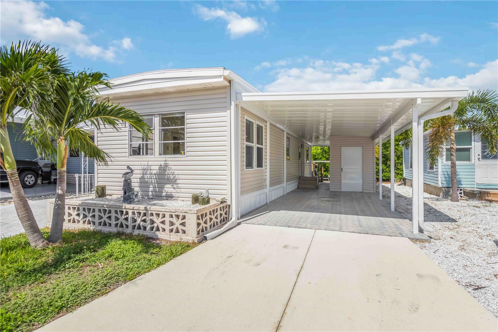 Waterfront with boat lift in Tropic Isles. Furnished one-bedroom, one-bath home with a spacious bonus/laundry room, large storage shed, and direct canal access to the Gulf of Mexico with no bridges. A 2019 boat lift with a 39-foot concrete seawall make this property perfect for boaters and fishermen. Recent updates include a new carport in 2025, new carpeting in 2025, new roof in 2018, new A/C and ductwork in 2019, new refrigerator in Aug 2025, new appliances in 2018, and fresh interior paint. The HOA fee is only $338 per month and covers water, sewer, trash, pool, clubhouse, library, and more. Tropic Isles is an active 55+ community offering a marina with fuel, bait shop, and boat ramp, plus a pool, spa, fitness center, library, card room, auditorium with kitchen, and a kayak launch. Save on marina fees and keep your boat right in your backyard—this is one of the most affordable opportunities for true Florida waterfront living.