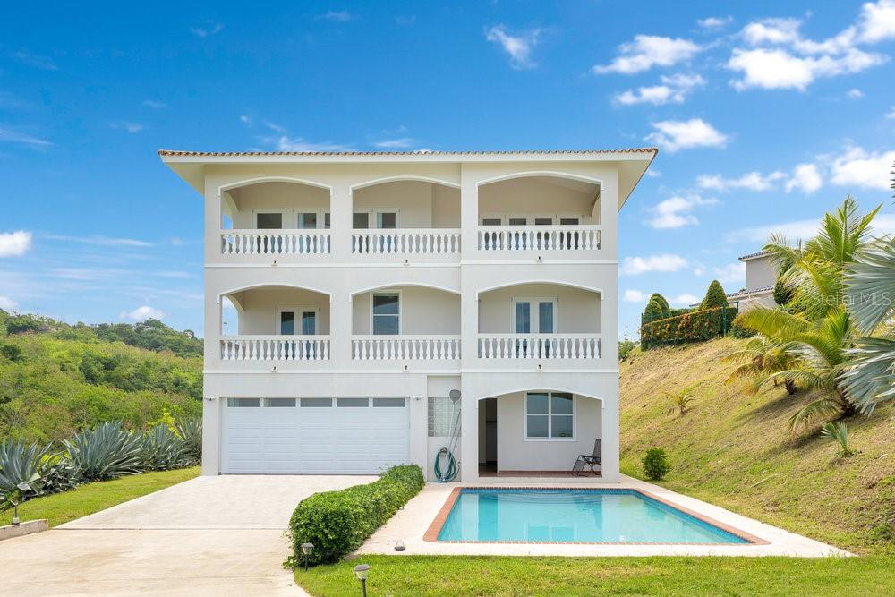 Beautiful contemporary home of 3 levels with a pool and fantastic ocean and sunset views! Located at the end of a quiet road of luxury homes, this 3 bedroom 2.5 bath home also has an in-law suite on the ground floor with a full bath. Huge balconies with accordion doors front the second and third levels. The kitchen and living area are on the top level, providing the best views and a wide open space for entertaining. The ground floor consists of a two car attached garage and the in-law suite with separate entrance. A perfect single family home or VRBO ready rental!