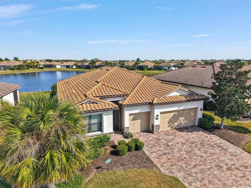 Resort living at River Strand Golf and Country Club! This club features a 27 hole golf course, 9 Har-Tru tennis courts, 8 pickleball courts, 2 club houses with pools, many satellite pools, 1 restaurant, 1 gym, a library, a card room, cornhole, live entertainment, and many sponsored events through an activity director including live music and shows. Enjoy 2287 square feet of living space overlooking a central pond view out back and a long view of another pond out front. Your home ownership social dues give you access to every amenity including golf. Arthur Hills designed golf course charges green fees and cart fees per use. You wont have to worry about lawn maintenance or trimming bushes as this maintenance is included in your dues. Reclaimed water helps keep your landscaping from drying out in the warm Florida weather. No worries about a community mail center when you can walk to your private mailbox at the end of your paver driveway. New accordion hurricane shutters and storm gutters installed in 2024. Enjoy care free resort living today!