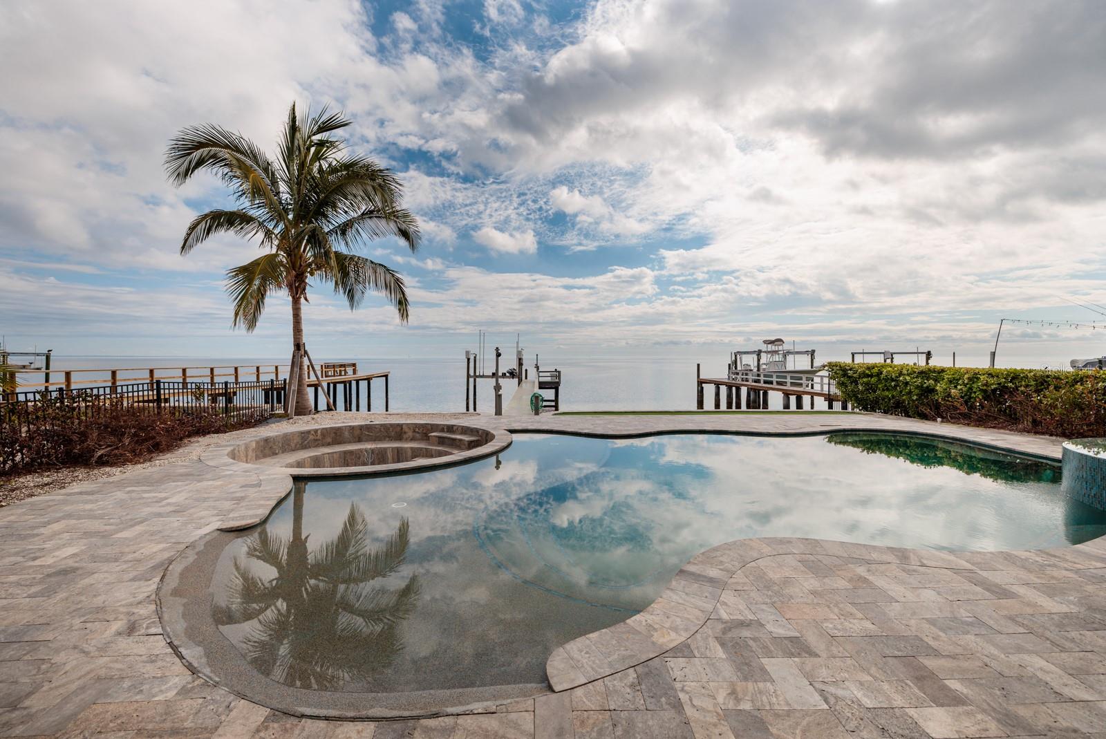 PRICE REDUCED!!! CHECK OUT THIS INCREDIBLE 3 BEDROOM 3 BATH 2 CAR GARAGE POOL HOME ON OPEN WATER TAMPA BAY. SOME WATER INTRUSION HAPPENED DURING HURRICAN HELENE. The dock is newer with water and electric and the boat lift held a 32ft Boston Whaler. The electrical panel and water heater are new. The upstairs bathrooms have been renovated and the house has all new hurricane windows and sliding doors. There are 2 brand new a/c units. The house is a 3 bedroom plus office and features an elevator. The place has a new pool and breathtaking views from most rooms. Seller has stopped renovations so price reflects that.