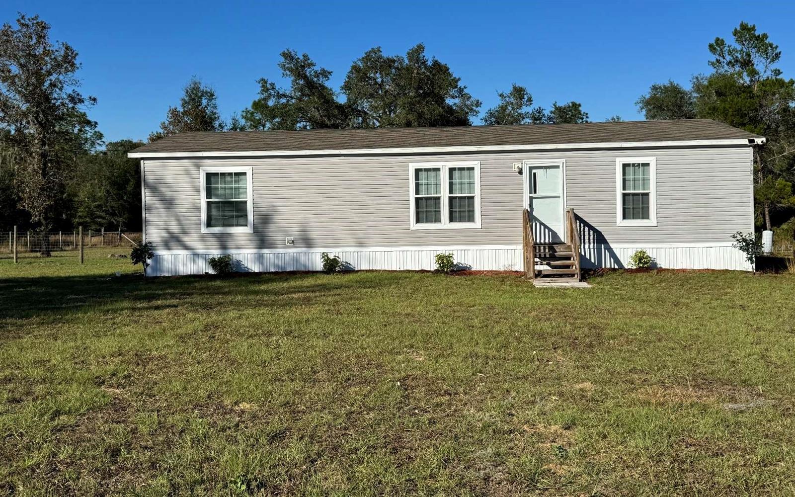 Country living on the outskirts of Gainesville or Ocala just off of Hwy 27. Convenient to larger towns, yet lower property taxes. Welcome to your home in the country! This 2018 3 bd/2ba home is in immaculate condition! Very well-kept and maintained with an open floor. Brand new tiled master shower. There is a chicken coop for you to harvest your own eggs located in the fenced in backyard.