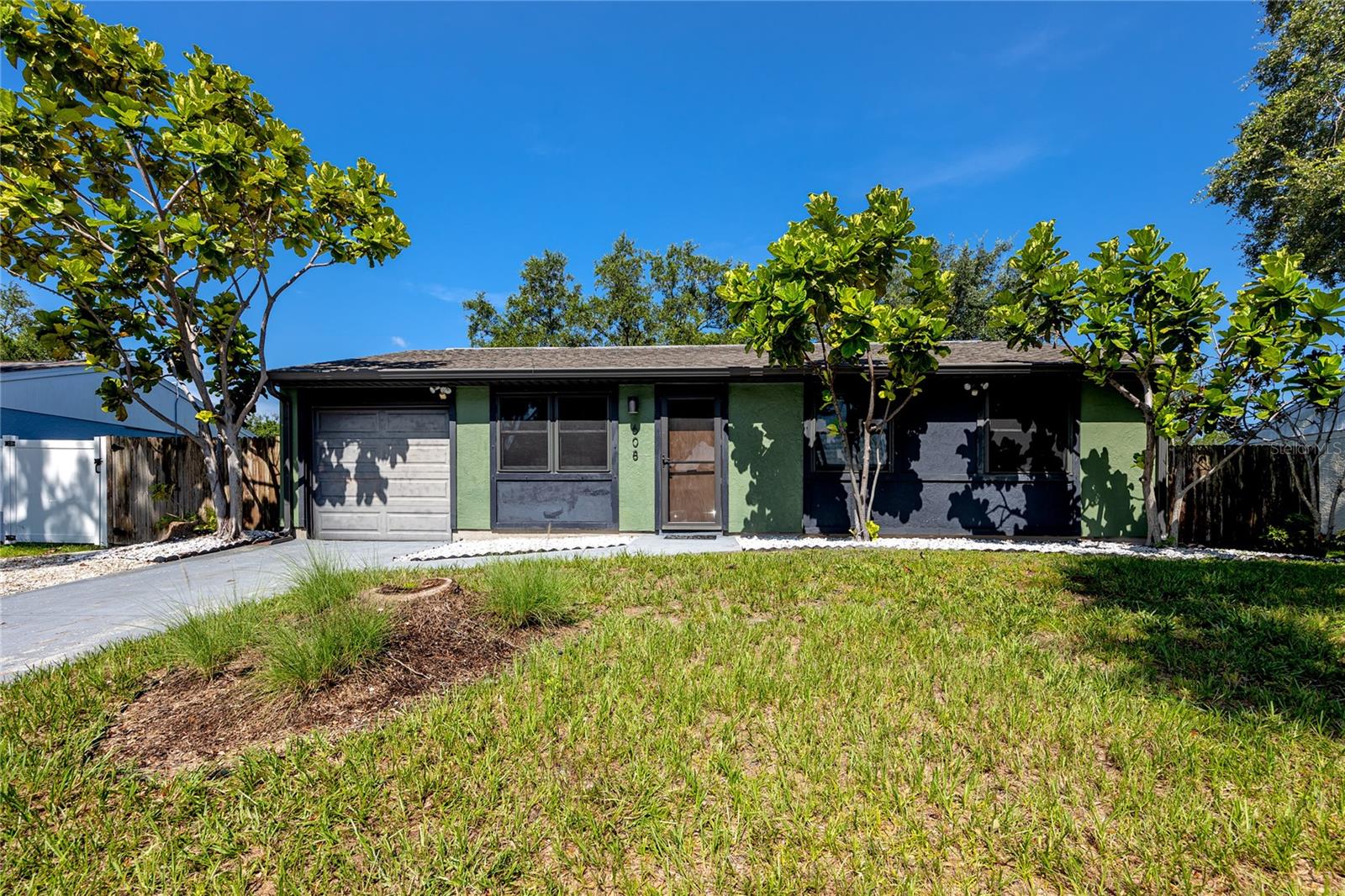 High & Dry Florida Oasis!
This stylish 3-bedroom, 2-bath home complete with an attached garage for added ease—a true gem that's move-in ready and packed with thoughtful upgrades. Set on higher elevation and untouched by recent storms or flooding, this home offers peace of mind year-round. Recent updates include ROOF (2021) with HURRICANE STRAPS, HURRICANE IMPACT PATIO DOORS & (2019), WINDOWS (2019), INSULATED HURRICANE IMPACT GARAGE DOOR, WATER HEATER (2021) WASHER & DRYER (2022). Stunning engineered HARDWOOD FLOORING (2022) throughout, MODERN SLAB TILE in the kitchen and dinette for a sleek, contemporary feel. Both bathrooms have been tastefully updated with meticulous detail, even down to the individually installed flooring pieces, a testament to the care and craftsmanship poured into this home. The garage, fully carpeted and A/C vented, offers easy attic access for storage with new ladder and garage can potential to convert into a bonus room. Just off the garage and kitchen is the spacious laundry room doubles as a workshop with a built-in tool bench. Whether you're sipping morning coffee on the porch, relaxing in the lanai, or soaking up the sun just outside your bedroom—this backyard’s got the perfect spot for every mood. A front parking pad perfect for your boat, golf cart, or extra vehicle. Located in a vibrant, welcoming neighborhood, this home is just minutes from everything that makes Oldsmar special. Enjoy sunset strolls to Mobbly Bayou Beach Park on the quiet community beach, take your kayak out from the launch, or if you have a bigger boat you can head 4 minutes down the road to the Oldsmar Boat Ramp. As a golf cart-friendly community, Oldsmar offers a fun and easy way to explore local parks, and community events, including those at Veterans Memorial Park, just a short ride away. This home blends incredible value, a prime location, and everyday comfort, all wrapped up in a stylish, move-in-ready space. Located just 12 miles from Tampa International Airport, this home offers convenient access to all major routes in every direction. Don’t miss the opportunity to make it yours!