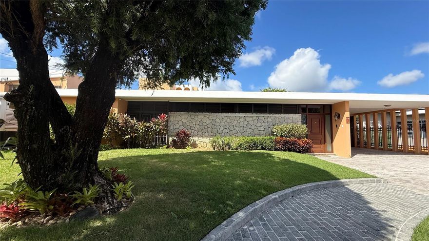 Experience the ultimate in luxury living in one of  Guaynabo’s most exclusive established gated communities. This classic timeless home is one of a kind designed by a renowned architect and meticulously crafted with an open concept living dining area, seamlessly flowing to the terrace, yard and pool area. The home features beautiful terrazzo floors among many other fine details. This expansive home boasts 6 bedrooms, 3 on the first floor and 3 oversized bedrooms on the second story with en suite baths, besides the maid’s or caretaker’s quarters. The master bedroom has generous proportions with many built-ins, and a huge walk in closet. The house also features a large pool, a covered terrace, a generator and a cistern. The exclusive gated community has a 24 guard at its entrance with excellent security, a park with tennis courts, a jogging track and playgrounds among other amenities. This unique home is a great canvas ready for a new owner to make it his own.