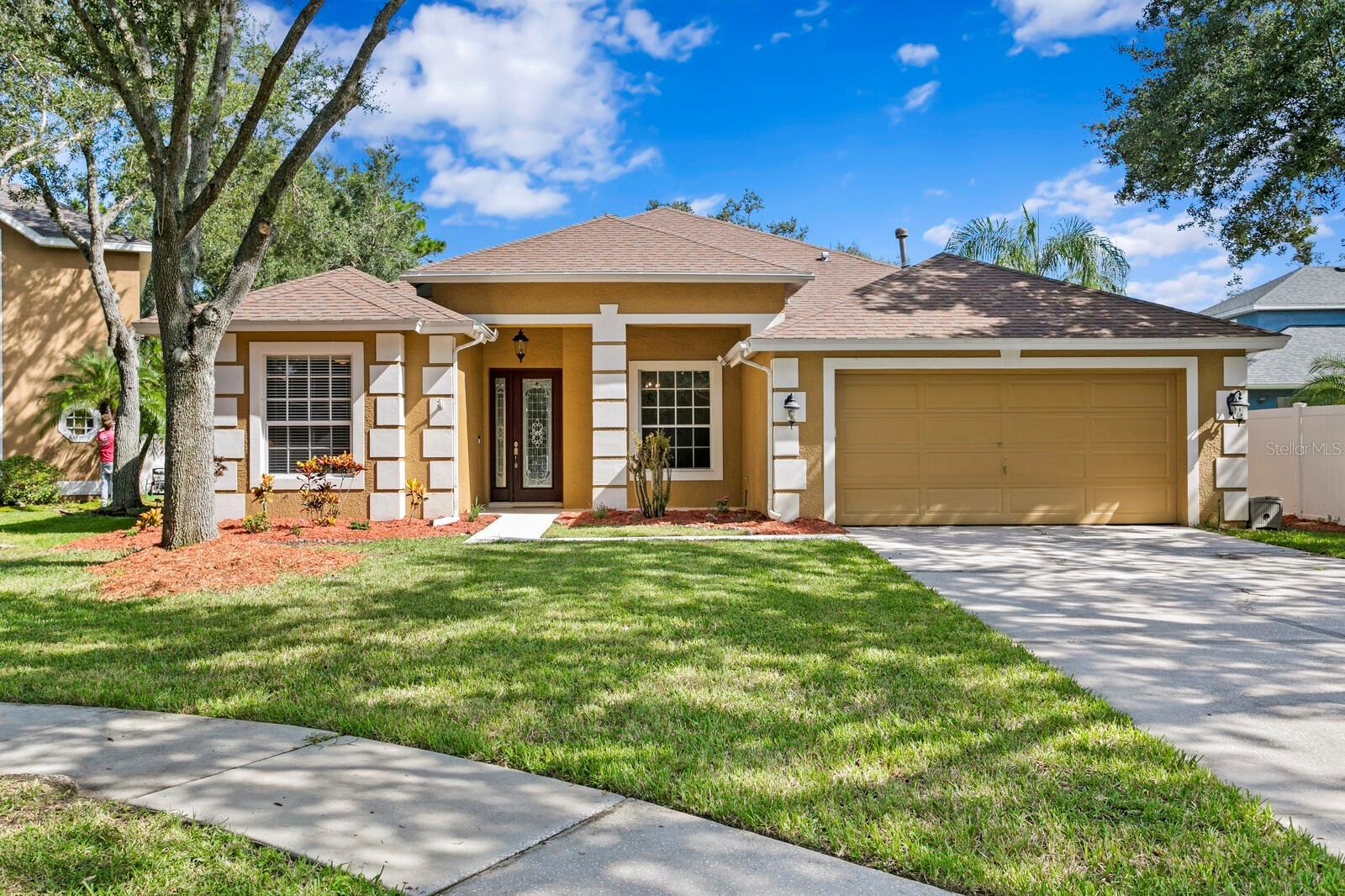 Tucked away on a peaceful cul-de-sac in Hawk’s Landing village of West Meadows, this pool home blends comfort, functionality, and style. A refreshed exterior with updated landscaping and inviting curb appeal sets the tone as you arrive. Step through the elegant arched entryway, framed by a curved cathedral ceiling, and you’re greeted by wood floors that flow throughout the main living areas. A formal living room sits to the right of the foyer, while two generously sized bedrooms with a full bath on the other side. The heart of the home showcases a kitchen designed for both beauty and practicality, featuring Corian countertops, stainless steel appliances, gas range, and canned lighting, along with an adjoining dinette for casual dining. The family room offers high ceilings and expansive windows overlooking the pool, creating a light-filled gathering space that flows seamlessly to the outdoors. The primary suite is privately positioned at the back of the home and features its own access to the lanai and pool area. The oversized walk-in closet provides excellent storage, while the primary bath offers a relaxing soaking tub and separate glass-enclosed shower. Off of the family room are two additional bedrooms that also share a full bath. This home is equipped with a brand-new gas water heater for added efficiency and peace of mind. Outdoors, a fully fenced oversized backyard which ensures both privacy and functionality. Relax at the end of the busy day while lounging at sparkling pool and spacious patio. The outdoor setting is the perfect setting for entertaining, with plenty of room for a grill, lounge area, and dining space. Residents of this vibrant community enjoy resort-style amenities with modest HOA fees, including a fitness center, lap pool, resort-style pool with slide, tennis and basketball courts, dog park, playground, and scenic walking trails. Conveniently located just minutes from top-rated schools, I-75, I-275, USF, hospitals, shopping, and dining, this home offers the very best of Florida living. Welcome Home!