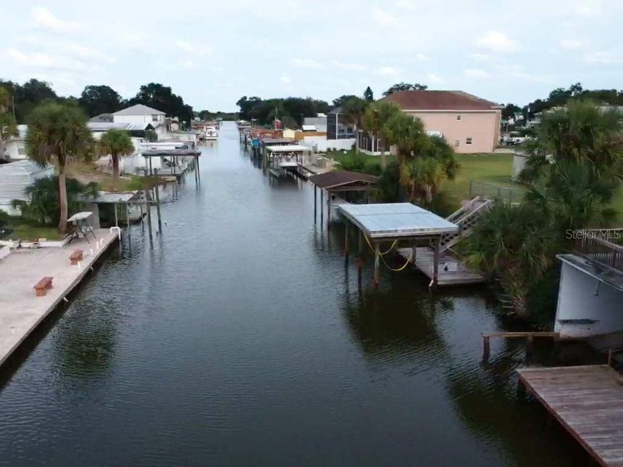 REDUCED! Fisherman's Paradise with direct frontage on a deep water canal leading to the Intracoastal Water Way. Waterfront includes dock with covered ramp style boatlift and additional deck with waterfront views. Located in the heart of the best red fishing in the world and just minutes boat ride to fun in the sun at disappearing island, New Smyrna Beach, or have a private day in the sun at many of the sandbars or barrier islands. Home features recently remodeled kitchen with high end wood cabinets, newer stainless appliances, lots of additional upgrades. Large living room just off kitchen with lots of windows and natural light. Oversized detached two car garage with possible additional living space and laundry room. Property features fenced backyard, storage shed, covered private front patio, carport, and lots of room for parking cars, RV or boat. No HOA! Only 45 minutes from Orlando. ;Water: City