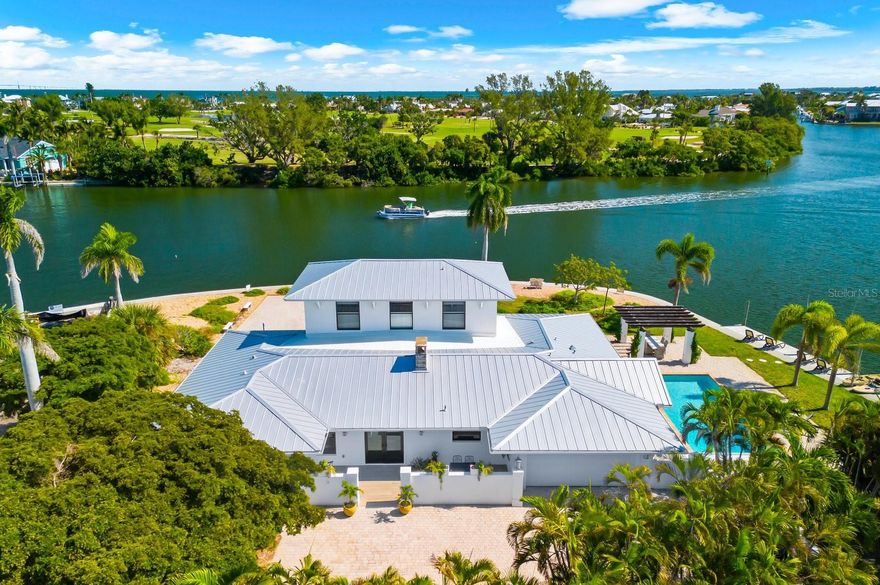 BIMINI BAY SHOWSTOPPER!
Quite possibly one LARGEST and most stunning lots on Anna Maria Island! Nestled in the desirable Bay Palms neighborhood of Holmes Beach, this custom-built 4-bedroom, 4-bathroom coastal masterpiece offers breathtaking panoramic views and an unmatched 260 feet of waterfront on an expansive 19,863 sq. ft. lot.
Boasting deep water access right at your doorstep, this is a boater’s paradise—perfectly positioned for enjoying open water breezes and spectacular sunsets. Originally built in 1959, the home underwent a complete top-to-bottom remodel in 2025, bringing it up to modern luxury standards while retaining its island charm.
Highlights include:
Hurricane-impact doors and windows throughout, Standing seam metal roof (2022), All-new plumbing, electrical, drywall, painting,fixtures, flooring, bathrooms, and kitchen, Gutters and exterior updates. Chef’s kitchen featuring custom LUXE cabinetry, quartz countertops, and ample workspace with a total of 4,285 sq. ft., this home blends elegant design and everyday livability—indoors and out. Whether you’re entertaining guests, setting off on a sunset cruise, or simply relaxing and soaking up the serene water views, this one-of-a-kind property delivers the ultimate coastal lifestyle.
Don’t miss your chance to own a true island gem in the heart of Holmes Beach—where luxury meets laid-back living.