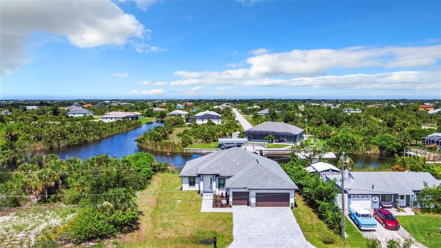 NO BRIDGES TO THE OCEAN. SAILBOAT ACCESS.   New, never lived in. 3 CAR GARAGE. Heated saltwater pool with attached spa. Heated outdoor shower with half bath on the Lanai near the pool. FISH from your private dock. Dual walk in closet in the master suite and private exit to the pool and lanai area from the primary suite. Toilet is separate from the remainder of the bath in the master suite. The kitchen features a waterfall granite island that is 12 feet long and can accomodate 6 diners for casual dining or breakfast. Dual overhead fans on the lanai and one or more foverhead fans in each interior room. A separate dining room tha is large enough to become a fourth or fofth bedroom as the GREAT ROOM is sufficient size to be a living dining area. THE HUGE LANAI is larger than most greatrooms and could easily become an enclosed game room if desired. Preconstruction appraised for $900,000. Seller wants a quick sale and has priced the house accordinly.