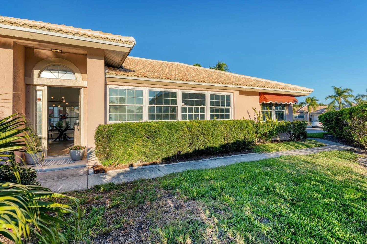 Situated in a quiet cul-de-sac within the maintenance-free community of Highland Lakes, you will find this stunning Arthur Rutenberg home. Offering an abundance of natural light and breathtaking lake views, it features the largest floor plan in the community with a split and open layout, ideal for modern living. There are multiple options for enclosing in a third bedroom. Updates include a 2020 AC, 2022 water heater, and a 2023 roof, along with impact windows for added peace of mind. The kitchen boasts beautiful quartz countertops and solid wood cabinetry. The quarterly HOA fee covers water, cable, and internet. There was no flooding or damage with any of the 2024 hurricanes!
