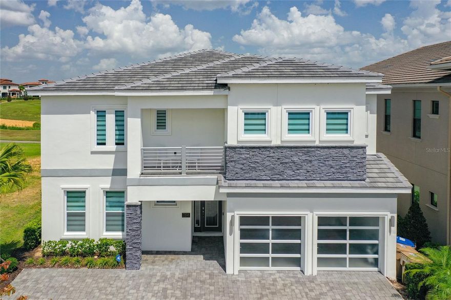 CONSIDER ALL THE POSSIBILTIES of this FULLY FURNISHED 11 bedroom, 11.5 bath, GOLF frontage home, perfectly placed on a quiet cuddle-sac in the spectacular Reunion Resort. Full of potential as an investment property or personal vacation retreat and ready to fulfil your vision and needs…. Professionally decorated, masterfully designed, and graced with sweeping golf course views of the 11th hole of the Nicklaus, this open concept floor plan excels at comfortably accommodating large numbers of guests with upper and lower gathering sections, a spacious, well-equipped kitchen, dining area, and covered outdoor living space with a summer kitchen that opens out to the pool and spa. Pride of Ownership throughout! The primary suite has a luxurious bathroom and is one of three bedrooms located on the first floor for convenience and accessibility. In addition to the remaining bedrooms, the second floor features the Media Room, Gym, Laundry, and an Entertainment Rec Room with Card Table, Arcade Game, Billiards Table, Dual Nascar Racing Machines and an extra-long Wet Bar with a refrigerator, beverage cooler and abundance of cabinetry. Other notable mentions: Bar Top Seating, Catering Island, Specialty Ceilings, Designer Lighting, Granite Countertops, Porcelain Flooring, Custom Blinds, Energy Efficient Windows, Smoke Detectors, Ceiling Fans, Front and Rear Balconies, Two Laundry Rooms, Pool Bath, Tile Roof, Paver Driveway and Pool Deck and a Garage that can be converted into usable space. Ample parking. Extremely Valued TRANSFERABLE MEMBERSHIP can potentially convey! Reunion Resort and Club is a GATED, GOLF community designed for the active lifestyle with 3 signature golf courses, tennis center, WATERPARK, 11 communal pools, playgrounds, putt putt golf, Spa, fitness center, arcade, DOG PARK and numerous on-site dinning choices. It is also a short-term rental community for additional advantages. Convenient to Central Florida's major roadways, attractions, dining, shopping and beaches! This home has never been in the rental pool and is around the corner from the back guard gate for quick access to Hwy 429 and I-4. A TURNKEY opportunity that is ready to go whether for your own purposes or as an addition to your investment portfolio. Come see why Reunion is a unique one-of-a-kind community and a coveted place to own!