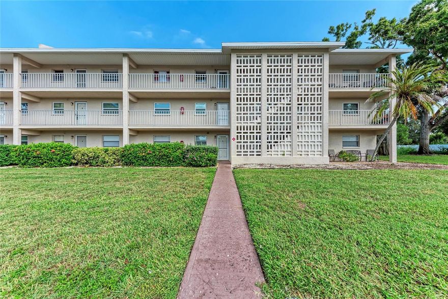 Imagine waking up each morning to the soft sound of birds dancing from tree to tree, coffee in hand as you sit on your peaceful back lanai overlooking a lush green courtyard. The gentle Florida breeze drifts through your open floor plan, filling the space with warmth and serenity — this is the kind of morning rhythm that makes every day feel like a retreat.
Welcome to this rarely available first-floor, larger-model condo in Tregate, a beautifully maintained 55+ community where comfort and convenience blend seamlessly. Originally a three-bedroom layout, the floor plan has been thoughtfully converted to create a spacious bonus or living area, offering the flexibility to entertain, relax, or create the perfect hobby space.
Inside, the kitchen has been tastefully updated with real granite countertops, rich wood cabinetry, and a clean, modern aesthetic that opens directly into the living and dining areas — perfect for hosting family or friends. The open-concept design allows natural light to flow freely throughout, enhancing the home’s bright and airy feel. The home is equipped with a washer and dryer in the unit for convenience.  
Step outside to enjoy your private lanai and the expansive green space just beyond your door — no parking lots or buildings in sight, just tranquility and privacy.
Residents of Tregate enjoy a friendly and active community with amenities that include a heated pool, clubhouse, and beautifully maintained common areas. Each building is equipped with an elevator, laundry facilities, and assigned covered parking, along with additional storage for your convenience.
And when it comes to location, you’ll love being just minutes from grocery stores, restaurants, golf courses, downtown Sarasota, and the white sands of Siesta Key Beach.
This inviting, move-in-ready condo offers the perfect combination of value, peace, and Florida lifestyle living — all in one of Sarasota’s most convenient 55+ communities.