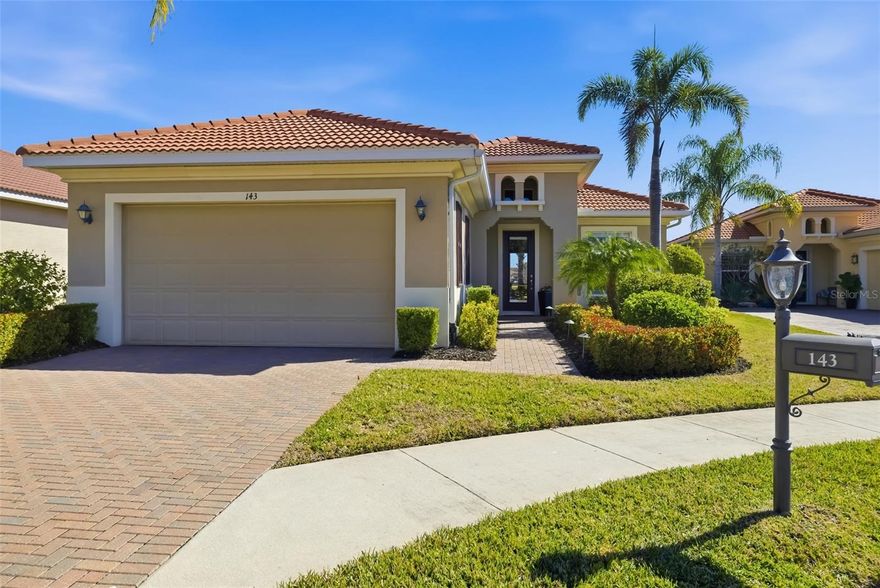 Long lake views framed by a lush nature preserve set the stage for a home where serenity and natural beauty greet you every day in the prestigious Venetian Golf & River Club. Ideally positioned on a quiet cul-de-sac, this meticulously maintained residence is designed for effortless living and timeless elegance. Tall ceilings, tray details, crown molding, plantation shutters, and neutral ceramic tile laid on the diagonal create a light-filled interior. The spacious living room features an 11-foot tray ceiling and a full wall of sliding glass doors that seamlessly blend indoor and outdoor living. The true highlight is the extended stone paver lanai with bronze screen enclosure and Storm Smart protection. Expansive lake and preserve views create a breathtaking backdrop; perfect for morning coffee, evening sunsets, and quiet moments surrounded by birds and wildlife. A chef-inspired kitchen showcases warm solid wood cabinetry with crown molding, granite countertops, subway tile backsplash, under-cabinet lighting, stainless steel appliances, and a breakfast bar. A sunny breakfast nook overlooks the lanai, while the formal dining room offers an inviting space for entertaining. The primary suite provides a peaceful retreat with tray ceiling, custom walk-in closet, and a spa-like bath featuring split vanities, soaking tub, walk-in shower with built-in bench, and private water closet. The split-bedroom layout ensures privacy, with two additional bedrooms complemented by a well-appointed second bathroom. A spacious laundry room with cabinetry and utility sink, a two-car garage with built-in storage, and a recently replaced HVAC system (November 2025) add everyday convenience. Beyond the home, life at Venetian Golf & River Club feels like a resort vacation every day. This gated community offers 24-hour security, two pools, the full-service River Club with dining and tiki bar, tennis and pickleball courts, fitness center, and a vibrant social calendar. Optional membership is available for the 18-hole Chip Powell championship golf course. All of this is set along a 70-acre nature preserve backing to the Myakka River, just minutes from shopping, dining, healthcare, historic downtown Venice, and pristine Gulf beaches.