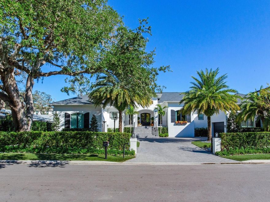 Welcome to this stunning newly constructed home, designed for effortless single-level living. Nestled high and dry, this residence remained unscathed during recent storms, showcasing its solid construction. The interior exudes a contemporary yet intimate atmosphere, combining comfort with warmth. As you approach, a covered entry adorned with lush, flowered landscaping welcomes you into the home. Step inside to discover soaring ceilings that enhance the sense of space. The layout features three spacious bedrooms on one side, each with access to private baths, and an owner's retreat on the opposite side with a morning breakfast adjacent to a cozy den. The heart of the home is a fabulous great room that flows seamlessly into a large kitchen, complete with an inviting eat-in nook. Large windows overlook the serene pool area and meticulously landscaped surroundings, creating a perfect backdrop for everyday living. The great room's sliding doors elegantly fold back to reveal a generous screened-in outdoor dining terrace, perfect for entertaining while enjoying views of the pool and lush greenery. A separate indoor dining area offers additional space for gatherings, ensuring that every meal feels special. There is also a very generous Media Room that overlooks the pool and includes a bar for those movie or game nights. In addition the back yard features a fire pit, putting green, and bug spraying system. For car enthusiasts, the property includes a two-car garage and a one-car garage, both with ample height for lifts, providing the potential for a six-car garage setup. The generator works the whole house as long as Tampa has natural gas available. This home perfectly balances elegance and practicality, making it an ideal haven for those seeking comfort and style.  This South Tampa location is conveniently located to A-rated schools, dining, shopping, entertainment venues, International Plaza, Raymond James Stadium, I-275, Tampa International Airport, Downtown Tampa, the Channelside District, bay bridges to the beaches and I-4 to Disney World.