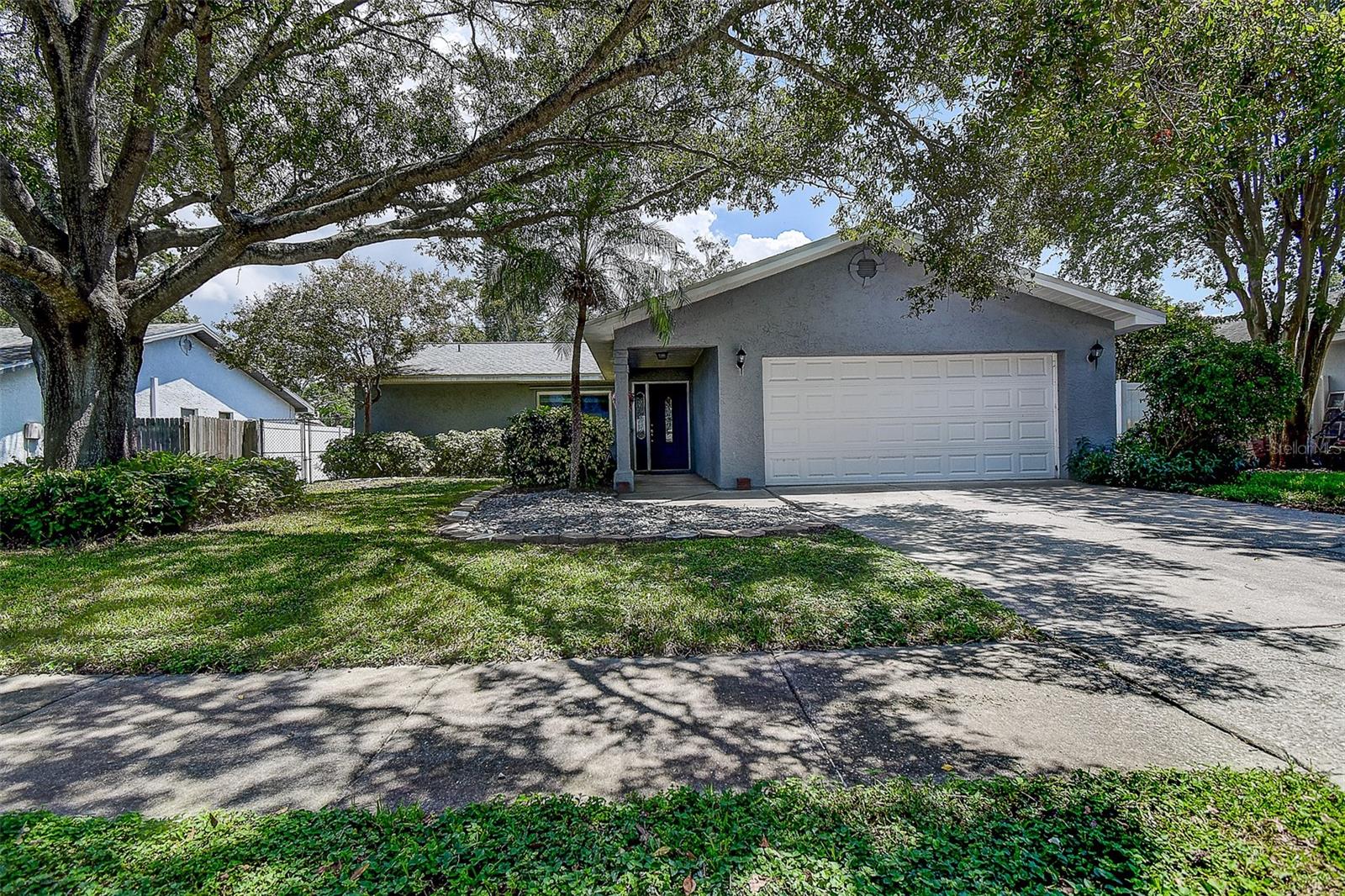 Welcome to your dream home nestled on a quiet dead-end street in the heart of Seminole! Surrounded by many newer homes in a non-flood zone!  This beautifully renovated 4-bedroom, 2-bath split-plan residence offers a perfect blend of modern updates and inviting charm. From the moment you step inside, you'll be greeted by a bright, open layout featuring fresh interior, luxury vinyl plank flooring throughout the main living areas, and a stunning kitchen complete with granite countertops and newer stainless-steel appliances. The spacious living and dining areas are ideal for entertaining, while the sunroom provides a peaceful retreat overlooking the fenced backyard. The primary suite boasts a private en-suite bathroom with granite finishes and a generous walk-in closet. With the indoor laundry room, it leaves plenty of room in the 2-car garage for all your toys. With a newer roof, and AC both installed in 2022, and a water heater from 2021, this home offers peace of mind and lasting value. Located just minutes from the award wining white sandy Gulf beaches, Lake Seminole Park, A rated schools, shopping, and dining, this move-in-ready gem won’t last long. Schedule your private showing today!