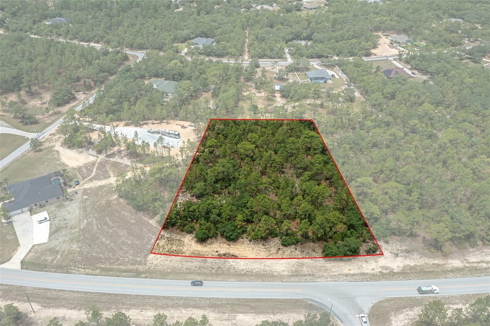 Welcome to Pine Ridge Estates, where 2.97 acres of pristine land offer the perfect canvas to build your dream home. Located in the highly sought-after "horses allowed" section, this expansive homesite provides the freedom and flexibility to create your ideal lifestyle. Whether you envision a private equestrian retreat, a spacious estate with room to roam, or simply a peaceful sanctuary surrounded by nature, the possibilities are endless. Unlike many communities, Pine Ridge allows RVs, boats, trailers, additional garages, and fences, giving you the freedom to design your property your way while still enjoying the benefits of a deed-restricted community. Beyond your own property, Pine Ridge Estates offers resort-style amenities designed for an active and fulfilling lifestyle, including lighted tennis and pickleball courts, shuffleboard, a playground, and even an RC fly field. For horse enthusiasts, this community is truly exceptional, featuring a 94-acre Equestrian Complex with a community barn for up to 17 horses, a main riding arena, and a dressage/jump/cross-country arena, all connected by over 28 miles of scenic horseback and walking trails. Adventure extends beyond Pine Ridge, with incredible outdoor destinations just minutes away. Spend your days boating, fishing, kayaking, or swimming in the Hernando Chain of Lakes or venture to the crystal-clear waters of the Rainbow River and Rainbow Springs, just a 30-minute drive. With the Gulf of Mexico also within easy reach, you'll have endless opportunities to explore Florida’s natural beauty. Don’t miss the chance to bring your vision to life in this one-of-a-kind community. Whether you seek adventure, relaxation, or the perfect balance of both, Pine Ridge Estates is the place to make it happen. Come see this incredible property today!
