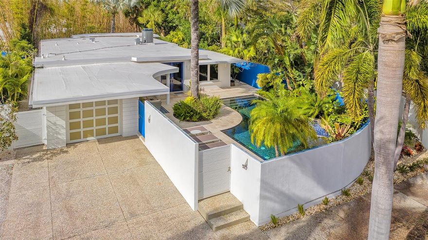 Welcome to your fully furnished dream home, where modern luxury meets natural serenity! Nestled just one block off the vibrant St. Armands Circle and a short bike ride to the pristine shores of Lido Beach, this impeccably remodeled mid-century modern residence is a coastal haven. Step into timeless elegance on the terrazzo floors that grace the home, featuring 2 living areas, a large dining room for entertaining and 4 bedrooms, with ensuite bathrooms, for the ultimate in comfort and privacy. Surrounded by lush foliage, the large travertine patio, adorned with a refreshing pool, offers a private oasis for you to unwind in the Florida sun. Privacy walls enhance the sense of tranquility, creating an intimate retreat amidst the greenery. As night falls, the enchanting outdoor lighting illuminates the landscape, setting a magical ambiance for evening relaxation.
Proximity to St. Armands Circle means endless dining, shopping, and entertainment options, while a short bike ride takes you to the sandy shores of Lido Beach. Enjoy peace of mind with a brand-new roof installed in 2023 and relish the modern convenience of all-new appliances and Hurricane impact windows, doors and sliders.This mid-century modern gem, surrounded by lush foliage and privacy walls, is not just a home; it's a lifestyle waiting for you to call it your own.