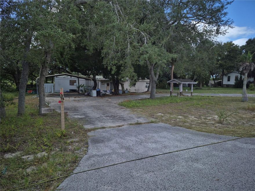 Looking for a spacious property with room to grow? This 1.4-acre lot offers a rare opportunity to own a generous piece of land with mature trees, open space, and plenty of potential.  The property includes a detached garage/workshop, perfect for storage, hobbies, or future renovation into additional living or workspace.  A mobile home sits on the lot and is in need of repairs and updates — a great option for investors, DIY enthusiasts, or anyone looking to renovate or replace with a new home