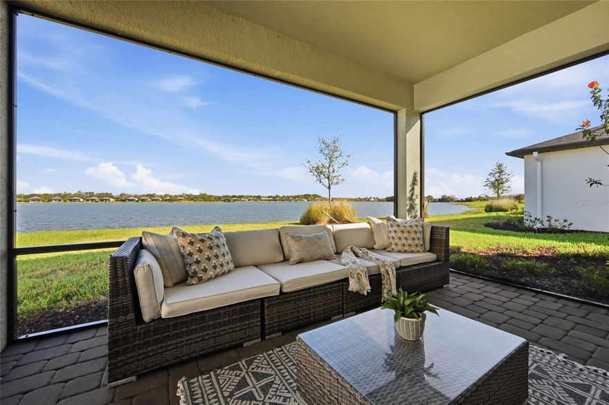 Boasting expansive long lake views, this recently built three bedroom residence delivers perfectly proportioned living in one of the newest completed maintenance-free Lakewood Ranch communities at Waterside.  Effortless living at Avanti in the 1,276 square foot Beachwood plan built in 2023 with a neutral and stylish palette, low HOA fees, and even all  IMPACT WINDOWS and DOORS.

Adjacent to the large under cover and screened lakefront lanai is the open concept kitchen where chefs will delight in ample cabinetry, quartz counters, pantry, stainless steel appliances, and intimate dining area,  all seamlessly connected to the inviting great room.

Relax and unwind in the privately situated primary suite, offering stunning lake views and awalk-in closet. Overnight visitors will be right at home with two additional guest suites on a separate wing, anchored by the home’s second full bath.

Other notable highlights of this maintenance-free smart home includes laundry room with the upgraded utility sink option already in place, all impact windows, sliders and doors, pavered lanai, drive and walkways, and a spacious two-car garage with the upgraded 4’ extension.

Avanti is ideally positioned within the #1 selling master-planned community in the U.S. with its proximity to Waterside Place at Lakewood Ranch. A bike ride or even walk to lively waterfront dining, shopping, farmer’s market, concerts and countless community events. Meanwhile, everyday living is at your fingertips surrounded by town centers, multiple restaurants, fitness centers, I-75, and UTC Mall, plus the added bonus that Downtown Sarasota is just 8 miles away, and the area’s world-famous white-sand beaches and SRQ Airport are just around the corner.