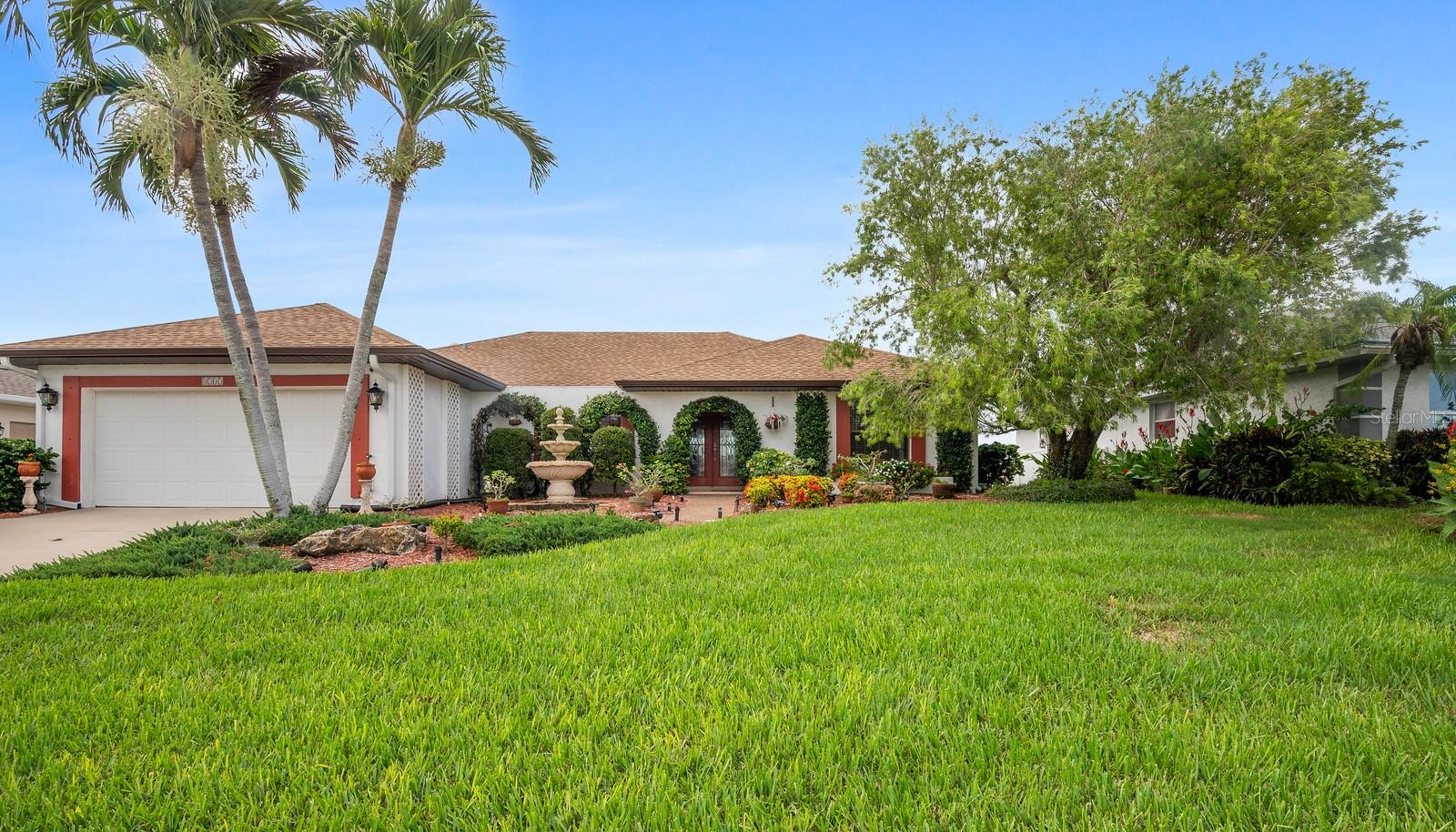 Lake Front Home In Bay Lake Estates with low HOA fees! Just minutes away from Bradenton Beach where you can enjoy the most amazing sunsets! Lanai faces north which benefits from consistent, indirect light and cooler temperatures due to the lack of direct sunlight, making it ideal for comfortable outdoor living, especially during the hot summer months! Beautifully maintained 3 bed 2 bath split bedroom home with large, primary ensuite and 20,000 gal. 9ft deep private pool. Private setting overlooking the lake where you can watch the sunsets from your lanai. This home boasts hardwood floors throughout the main living space and spare bedrooms and granite countertops in kitchen and guest bath. You'll find the primary suite with gorgeous terra cotta floors, two large dressing rooms and updated shower with glass door. This home has sliders to lanai from the living room, kitchen, primary bedroom, and back guest bedroom. There is a hot tub and koi pond within the screened lanai and you can step out of the pool area to the private outdoor shower on the west side of the house. This home sits at 12' elevation, has a hip roof, large garage with new epoxy floor, hurricane shutters and yard is landscaped with many plants, trees, and shrubs irrigated with reclaimed water.
**Updates** HVAC- has UV filtration/air purifier, compressor 2017, air handler 2009. Water heater (40 gal) 2020. Siemens 200amp electrical panel 2005. Roof 2016. 4-point inspection report available from July 2024.