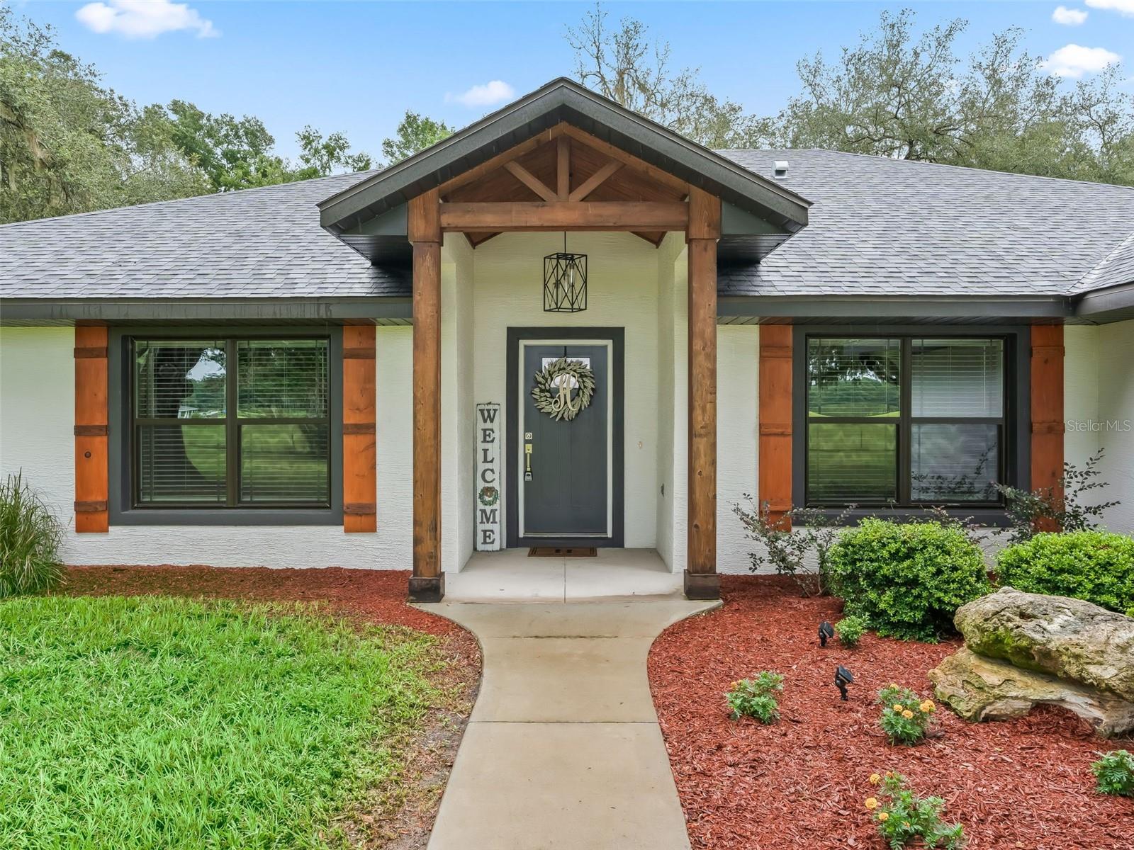 Welcome to your dream property! This gorgeous block home, set on 10 peaceful acres, combines modern elegance with country charm. Inside, you’ll find bright, open living spaces with crisp, clean finishes, tile flooring in the main areas, and plush carpet in the bedrooms for comfort. The owner’s suite is truly a retreat—featuring a tray ceiling with a cozy sitting area, dual walk-in closets, and a private hallway leading to the luxurious ensuite. The spa-like bathroom boasts a walk-in tiled shower and a relaxing soaker tub, perfect for unwinding after a long day. The heart of the home, the kitchen, offers a bar for casual dining, a sunny breakfast nook, and plenty of space for gathering. Step outside to the screened-in back porch where you can sip your morning coffee while enjoying serene views of deer and playful fox squirrels right in your backyard. Beyond the home, the property is well-equipped with a 24x20 shed and a spacious pole barn—ideal for storing equipment, tools, or starting your next hobby farm. With room to roam and space to breathe, this property gives you the best of both worlds: a modern home in a private, natural setting. I-75 is only a few miles away. Groceries, shopping and dining are all within a 15 minutes of this retreat. Don’t miss the opportunity to make this beautiful estate yours. Schedule your private showing today and experience the lifestyle you’ve been dreaming of!