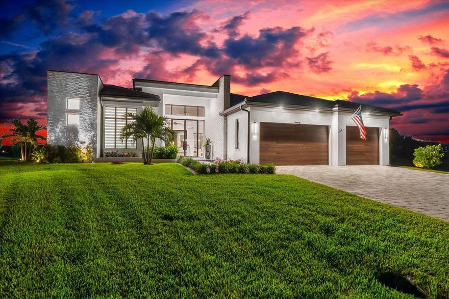 Introducing an extraordinary waterfront residence designed by the renowned Sater Design Group, celebrated for their award-winning designs worldwide. This custom-built soft contemporary home sits on an oversized 0.34-acre lot with stunning intersecting canal views and direct boating access to Charlotte Harbor and the Gulf of Mexico. Offering 2,836 square feet of air-conditioned living space plus 1,648 square feet of unconditioned areas, this home delivers a complete lifestyle experience inside and out. A dramatic glass entryway welcomes you through 10-foot double glass doors with sidelights and a transom window above, setting the tone for the thoughtful architectural details and upscale finishes throughout. The open-concept interior includes three spacious bedrooms, three full bathrooms, and a dedicated office. Soaring ceilings, 8-foot solid core shaker interior doors with Emtek hardware, and PGT impact-resistant casement windows and sliders fill the home with natural light and serene views. The chef’s kitchen features high-end Thermador appliances—including an induction cooktop with vent hood, double ovens, built-in side-by-side fridge and freezer, full-size wine cooler, and under-counter microwave—all integrated into custom double shaker cabinetry with glass display uppers and quartzite countertops. A floating buffet anchors the adjacent dining area, while a large walk-in pantry adds a second Bosch dishwasher, custom cabinetry, and quartz workspaces matching the kitchen and laundry room. The owner’s suite is a private retreat with a spa-inspired bath showcasing a freestanding Jacuzzi tub, glass-enclosed shower under soaring 12-foot ceilings, floating vanities with quartz counters, Kohler sinks, and a Toto Washlet. Built-in drawers feature integrated power and custom organization, and the spacious walk-in closet includes attic access. Outdoors, enjoy a resort-style setting with two large covered lanais—perfect for lounging, dining, or entertaining. One lanai features a fully equipped outdoor kitchen ideal for alfresco meals. A custom-designed pool and spa sit at the heart of the outdoor space, enclosed in a picture-frame cage. The pool features a Caribbean blue pebble finish, elevated interior sections for water sports, a sun shelf, a matching tile spa waterfall, LED lighting, and remote control. Over 1,400 sq ft of tumbled marble pavers in a French pattern surround the pool and outdoor shower area, creating a luxurious and durable entertaining space. The oversized lot is professionally landscaped with decorative rock along the canal edge, lush St. Augustine/FloTam sod, and a full irrigation system fed by canal water. Built for efficiency and durability, the home features 12-foot-high CMU block exterior walls with foam insulation, a flat concrete tile roof, with waterproof membrane, a spray foam-insulated attic with no soffit vents for a sealed system, and an oversized Trane HVAC. A hybrid 50-gallon water heater with heat pump and recirculating system boosts efficiency. Additional features include a three-car garage with epoxy flooring, custom CHI doors, jackshaft openers, and impact-rated service door, plus a charcoal/gray French-pattern paver driveway that enhances curb appeal. This exceptional property offers a rare blend of cutting-edge design, luxury finishes, and direct access to some of Florida’s most desirable waterways. This home must be seen to appreciate.