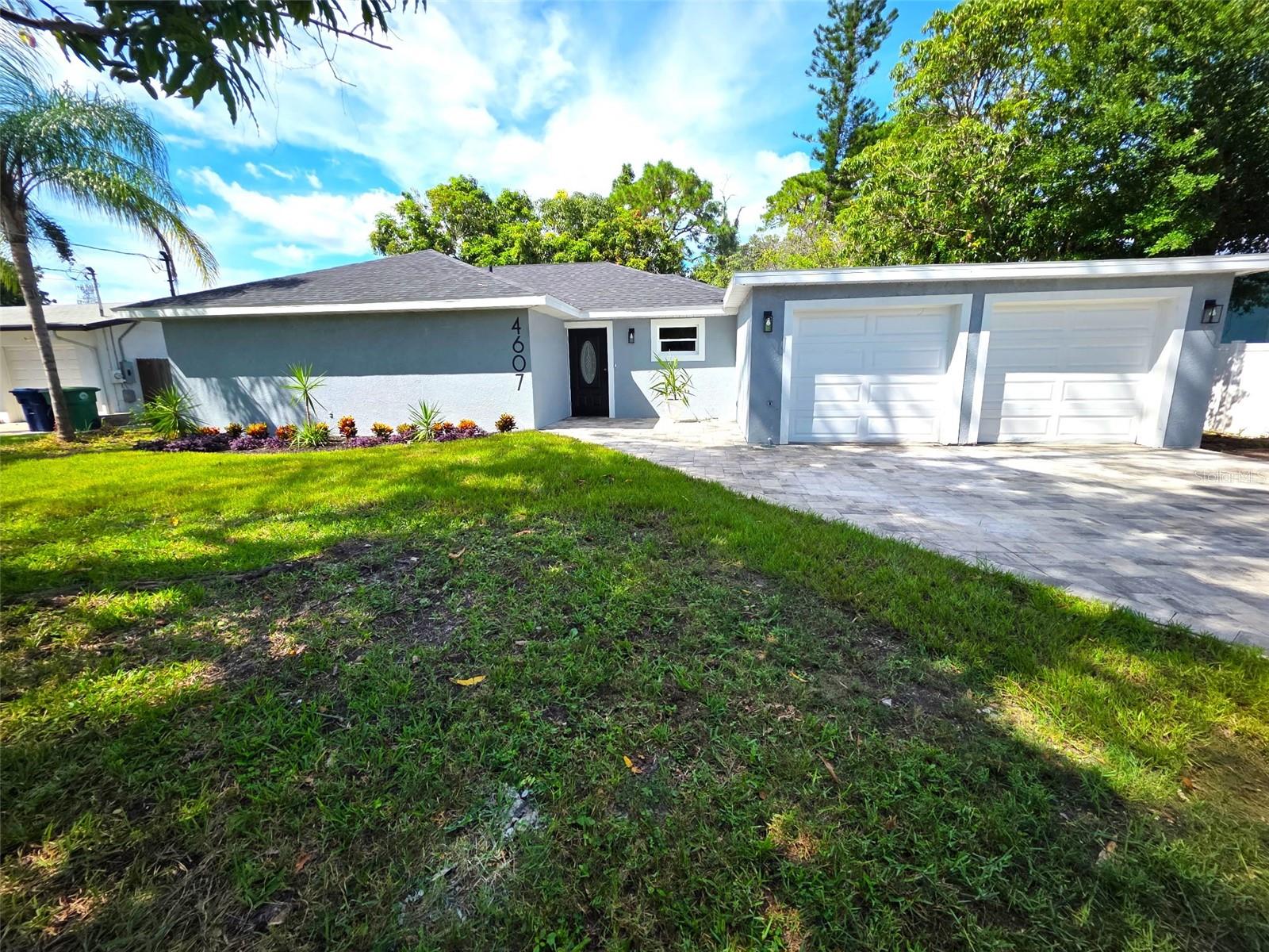 One or more photo(s) has been virtually staged. Here it is, the one you've been waiting for! This beautifully renovated South Tampa home is just minutes away from the Selmon Crosstown, making getting to the beaches or downtown Tampa a breeze! The fully transformed home has undergone a multi-year renovation by professionally licensed contractors. The sharp new black roof contrasts perfectly with the gray paint and white garage doors that greet you as you pull into the stunning and massive brand-new paver driveway, along with mature mango trees in the front and other colorful Florida landscaping. Through the front door, you'll find the entire home is modern and bright as you're greeted by an open kitchen that features all new stainless appliances, white shaker cabinets, and gorgeous custom white marble counters with subtle blue and black veining that add to their appeal. These countertops go great with the gray wood look tile throughout the home, which also ties together the bright and luxurious primary bath that features his/her sinks, and massive dual rain head shower. The guest bath is also upgraded, with a brilliant white tub, subway tile and upgraded black geometric tile floor, pulling together to make a gorgeous secondary bathroom. Combined, all these features create a great place to enjoy family time or to use for entertaining friends year-round. With a brand-new paver patio outside, more fruit trees, mature landscaping, and much more available space than typical lots in the area, your back yard is just as much an oasis as the inside. Although this home needs nothing, there’s plenty of room for adding a pool which the owner can include in the sale if desired.
Everything has been done for you, so this home is ready to move into and enjoy for years to come. Partial owner financing may be available, can close quickly - this one is a must see and won't last long!