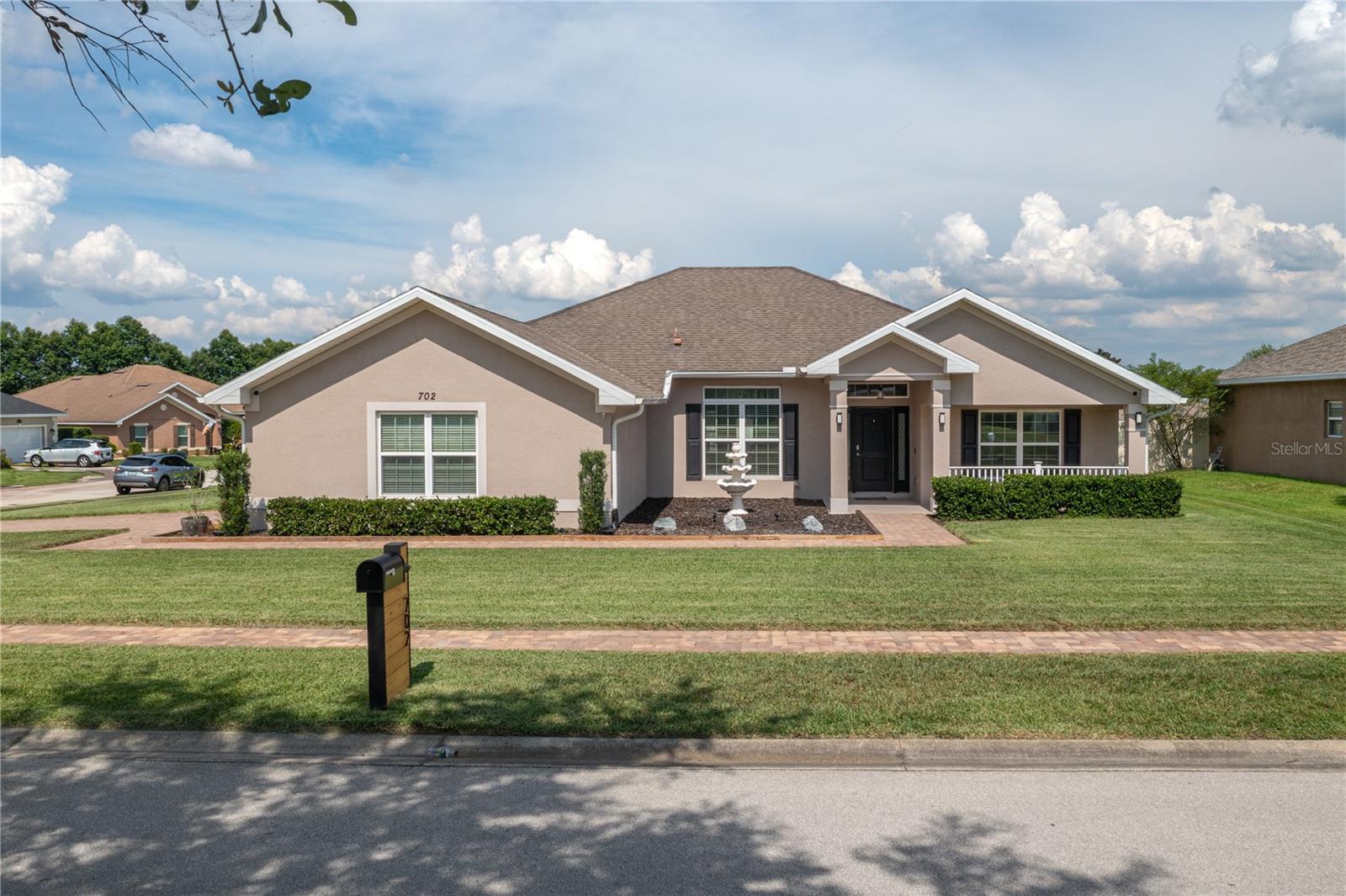 Welcome home to 702 Country Walk Cove, Eagle Lake. Previously the model home for Adams Homes. Discover the perfect blend of comfort, space, and thoughtful upgrades in this beautifully maintained 4-bedroom, 3-bathroom Adam's home located in the desirable Country Walk community of Eagle Lake. NO CDD FEES AND LOW HOA fee 526.00 Annually. Offering 2,332 heated square feet and 3,059 total square feet, this spacious residence is designed to accommodate modern living with ease. Step inside to an open, split-bedroom floor plan that includes a private guest suite—ideal for multigenerational living or visiting guests. The primary suite is a true retreat, featuring a dual vanity with granite counter tops, a glass-enclosed shower, and a soaking tub for ultimate relaxation. The kitchen is both stylish and functional, boasting granite countertops, updated cabinet hardware, and large bar that provides for entertaining. The home offers modern lighting throughout. The current owner has thoughtfully upgraded the home with all-new light fixtures and ceiling fans, a screen door for the garage, and LED exterior lighting perfect for holiday displays or year-round ambiance. Enjoy peace of mind with a PVC privacy fenced yard with a double gate for side yard entry—engineered with clips and locks to hold strong during windy Florida storms.  It is fully wired for generator hookup to keep you powered up in an emergency. (Generator not included but can be negotiated). Double-insulated windows contribute to excellent energy efficiency. A full irrigation system ensures your meticulously landscaped yard stays lush all year long. Landscape uplighting further enhances the home’s curb appeal with the LED lighting in the evenings. Freshly painted on exterior in 2025. This home offers move-in-ready convenience with the benefit of newer, stylish finishes and important special updates already completed. Don’t miss your chance to own this exceptional property in Eagle Lake. Call today to schedule your private showing!