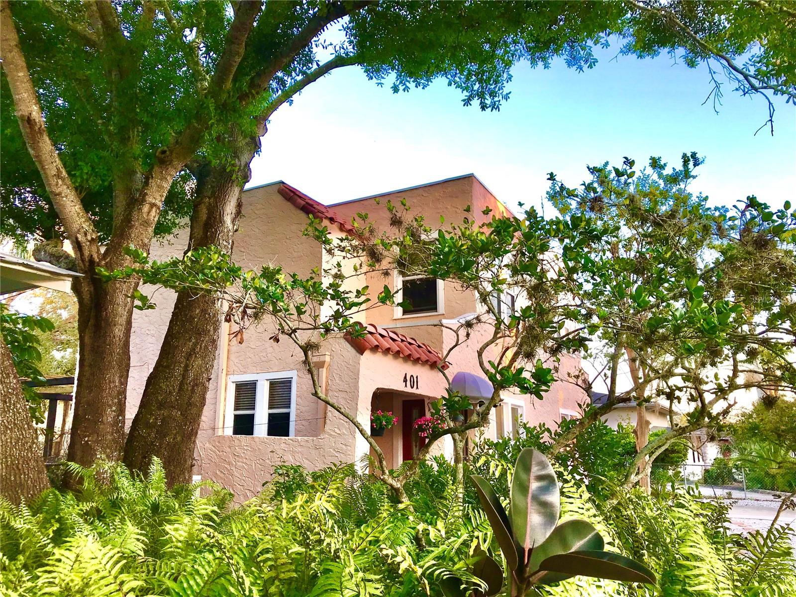 Step into Timeless Spanish Mediterranean Charm in the heart of the Historic River District – where elegance, history, and location come together beautifully. This one-of-a kind historic home is nestled in the heart of Bradenton, where the Riverview Neighborhood and Fogartyville meet, just two blocks from the Manatee River. Perfectly situated on high and dry land outside of any flood zone, this updated Old World retreat is built like a fortress, standing strong against hurricanes while exuding warmth and character. With no HOA or deed restrictions, this property offers true freedom and flexibility for homeowners. Located just 8 miles from Anna Maria Island, two miles from downtown Bradenton, and only 25 minutes from SRQ Airport, this home provides convenient access to the best of Florida’s Gulf Coast. As you enter through the iron-gated portico, a constant breeze welcomes you into an inviting and creative space. Inside, the open entryway flows seamlessly through an arched passage into the light-filled living room, complete with a cozy fireplace. A delightful faux bookshelf doorway leads to a private reading nook, a hidden gem that never fails to captivate guests. Beyond another arch, the elegant dining room boasts two built-in corner cabinets, and the well-designed kitchen features a wrap-around counter, ideal for buffets or extra workspace. An efficient gas stove makes cooking a pleasure, while abundant cabinetry ensures ample storage. The adjoining laundry and mud area provide added convenience, with a back door leading to the expansive deck that spans the width of the home. French doors from the dining room open into a covered, tiled lanai, offering another tranquil outdoor space. The large, fenced backyard is a thoughtfully designed Templar Garden—low maintenance, Florida-friendly, and spacious enough to accommodate a boat, Airstream, additional vehicles, or even a future pool and garage. Architectural plans for a garage in the home’s style will be provided. A wide and gracious staircase leads to the second level, where a bright gallery connects three inviting bedrooms. The master suite is a peaceful retreat, featuring a new sink, a jacuzzi tub, and a separate shower. The second bathroom maintains its original charm with a vintage cast iron sink and a large walk-in shower, while all three bathrooms have been updated with new Kohler toilets. This enchanting, light-filled home is a true sanctuary, offering historic elegance with modern convenience in one of Bradenton’s most sought-after neighborhoods. Step inside, feel the warmth, and envision your life in this dream home.